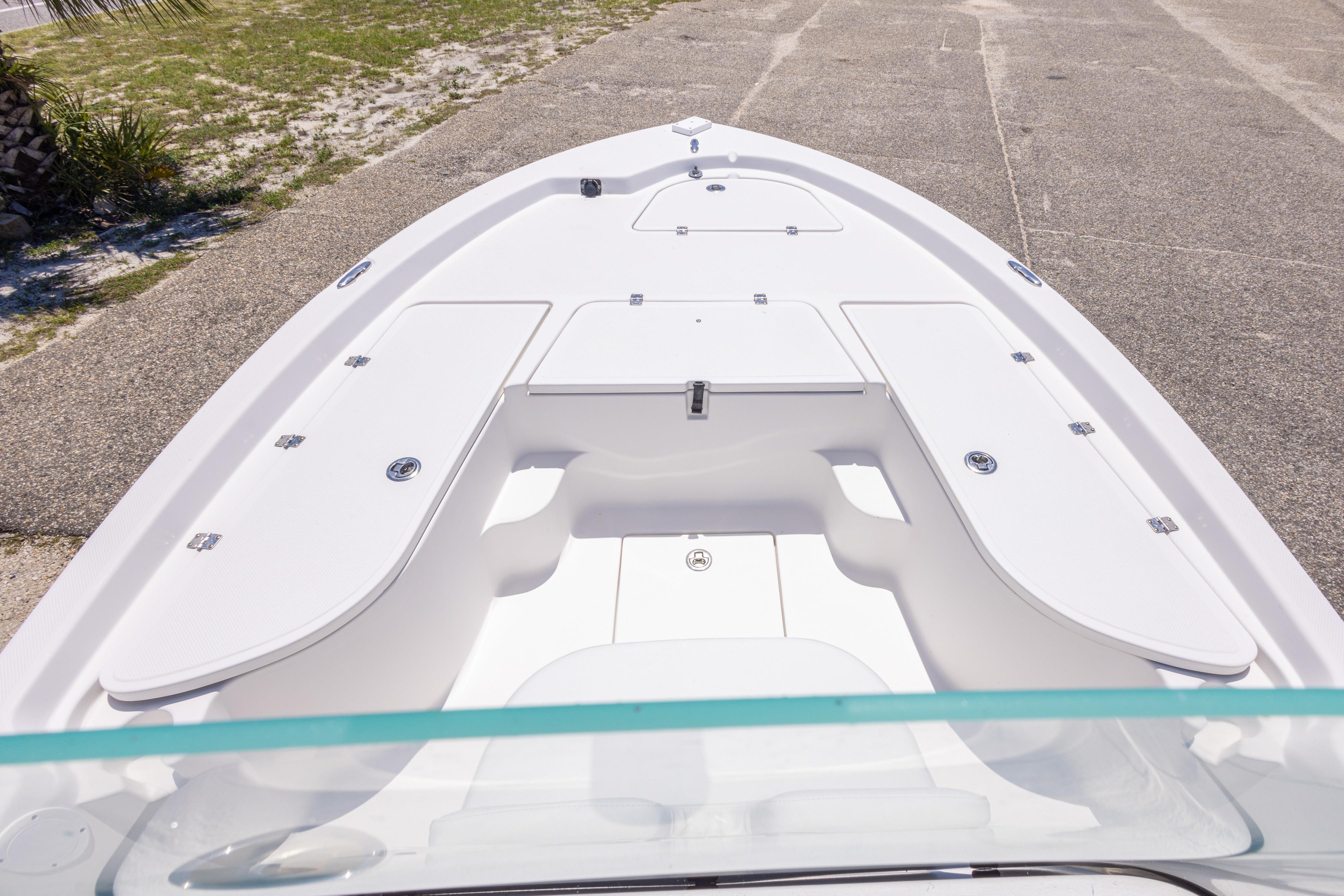2011 Sea Fox 200XT boat deck with storage compartments, parked on concrete.