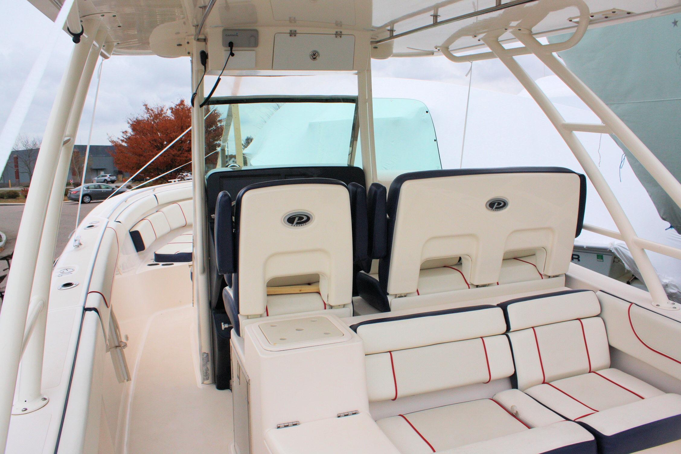 2013 Pursuit ST 310 Sport boat interior with cushioned seating and helm station.
