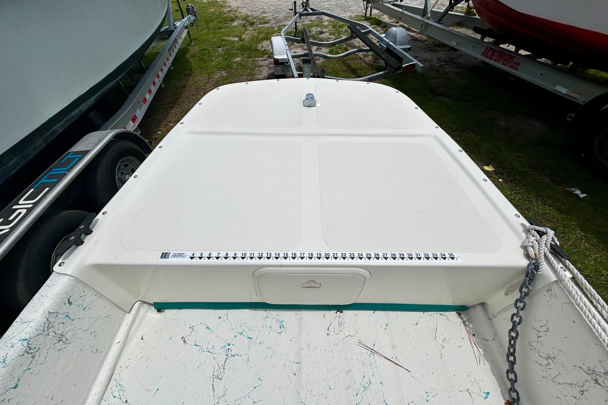 2002 Sundance K16CC boat deck with measurement scale and trailer.