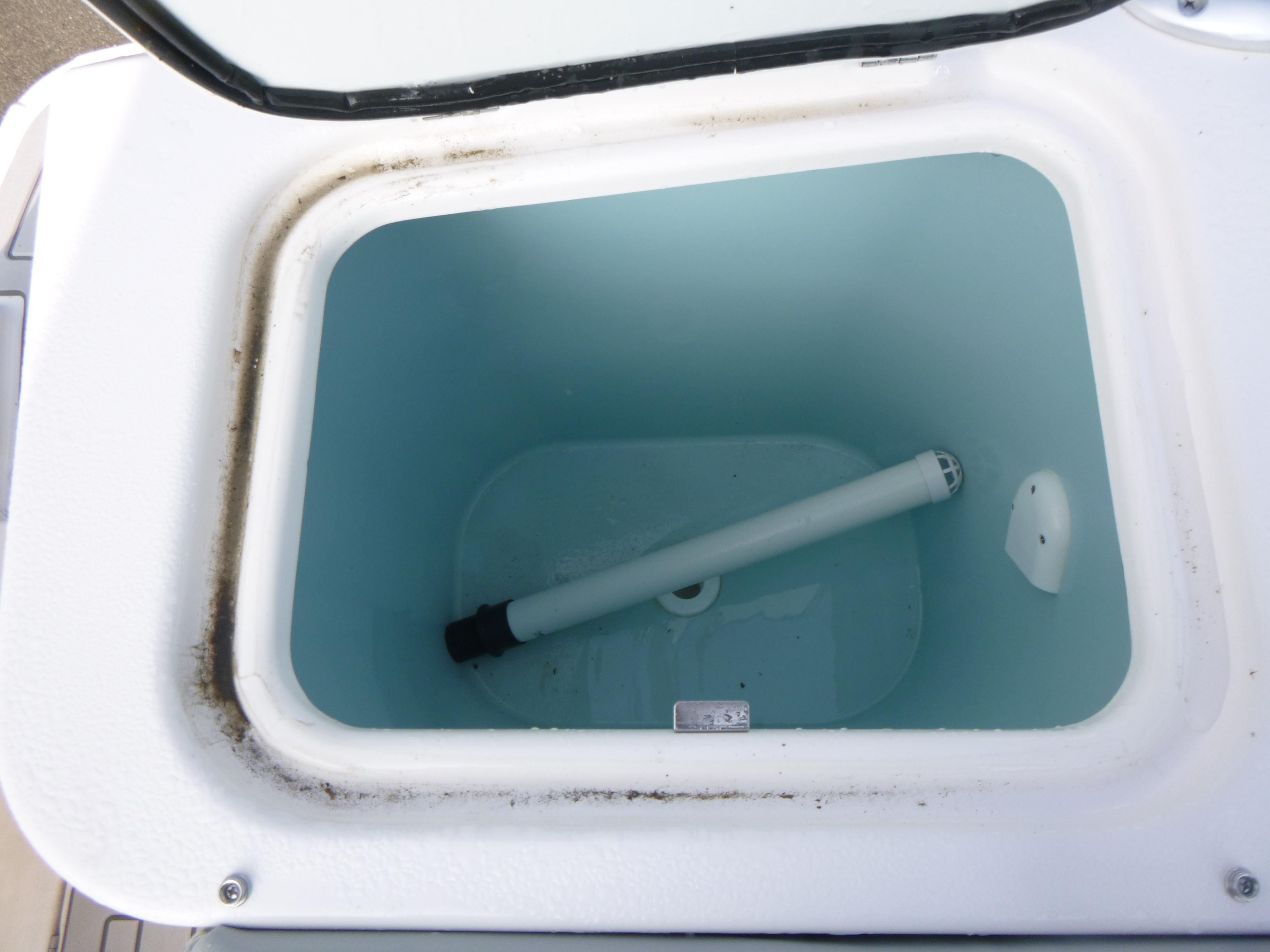 Open storage compartment of Solara S-250 CW 2025 boat, showing interior details.