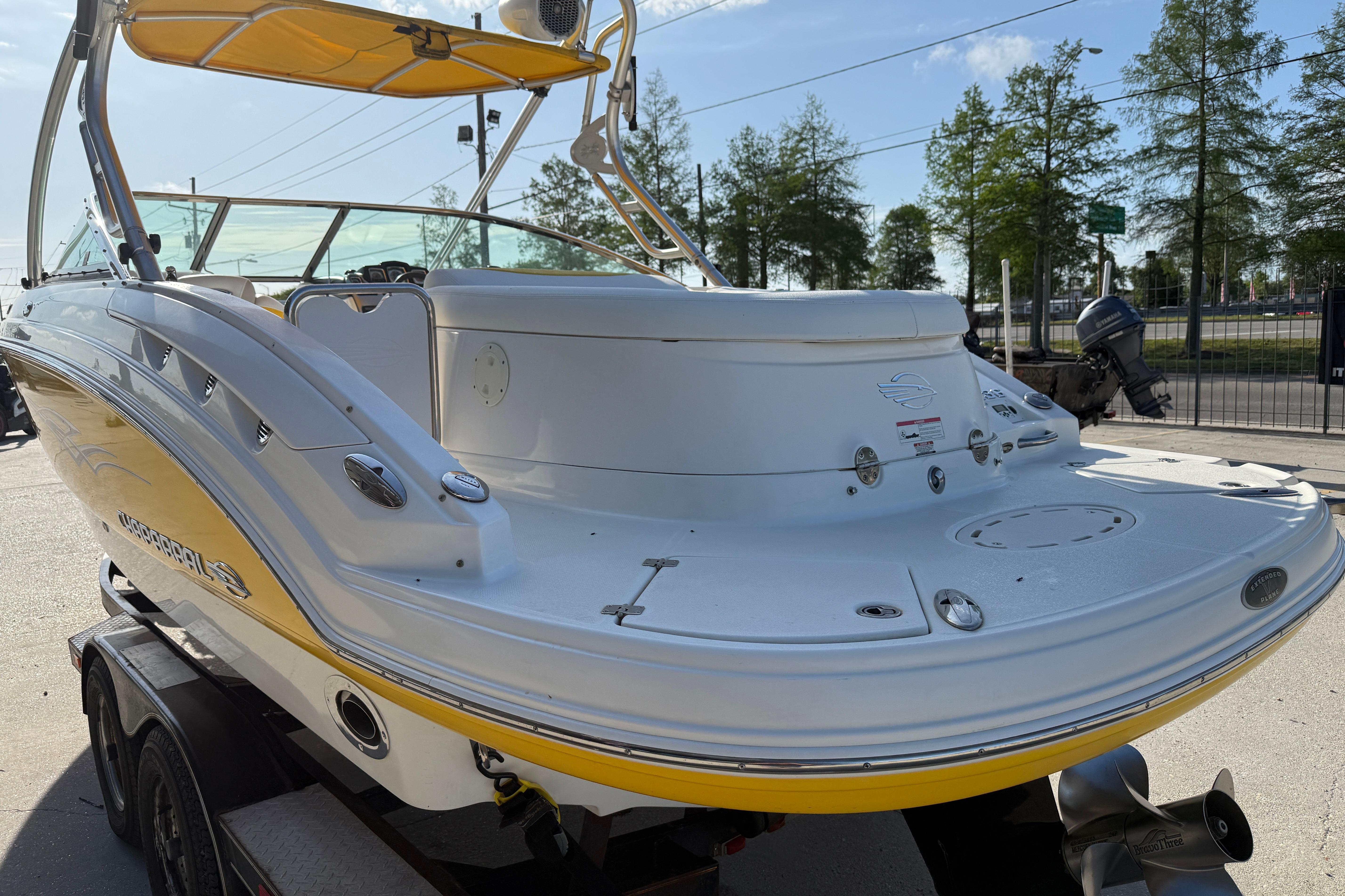 2008 Chaparral 236 SSX boat with yellow accents, parked on a trailer.