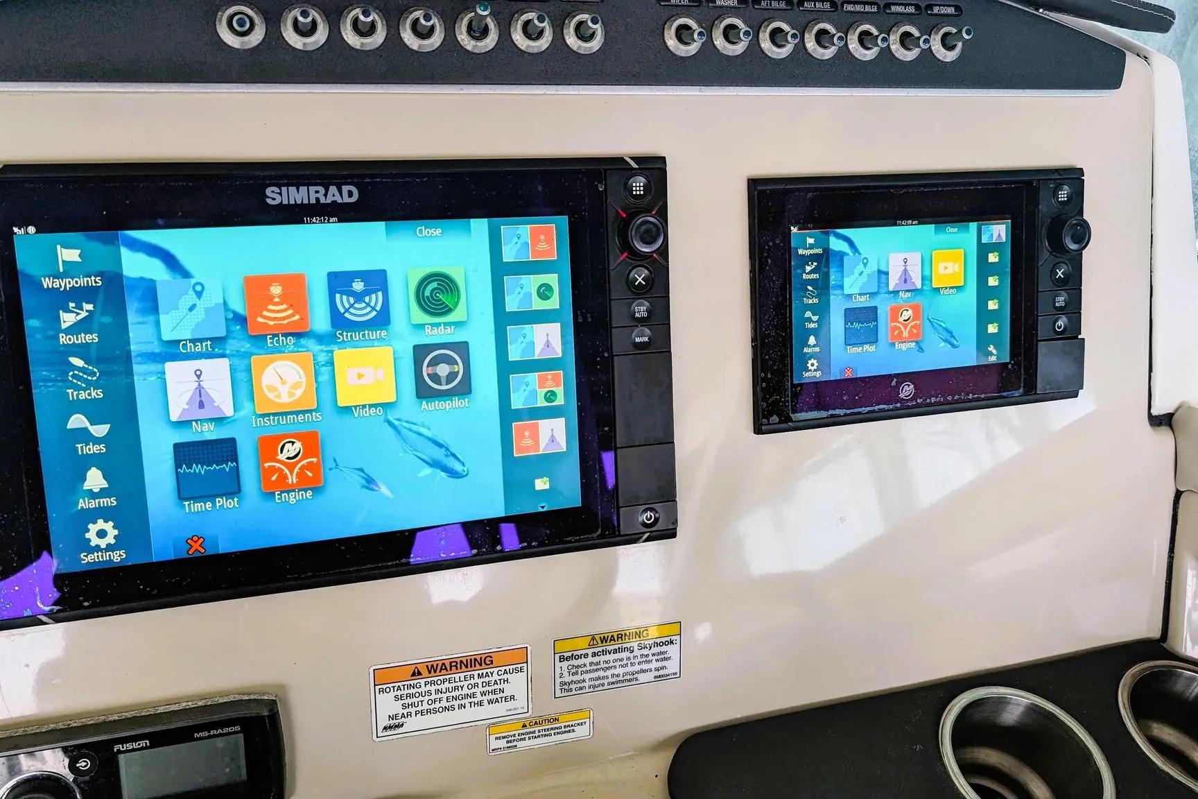 Simrad navigation screens on a 2017 Boston Whaler 320 Vantage boat dashboard.