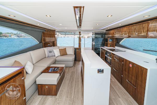 Luxurious interior of 2025 Riviera 645 SUV yacht with modern furnishings and panoramic windows.