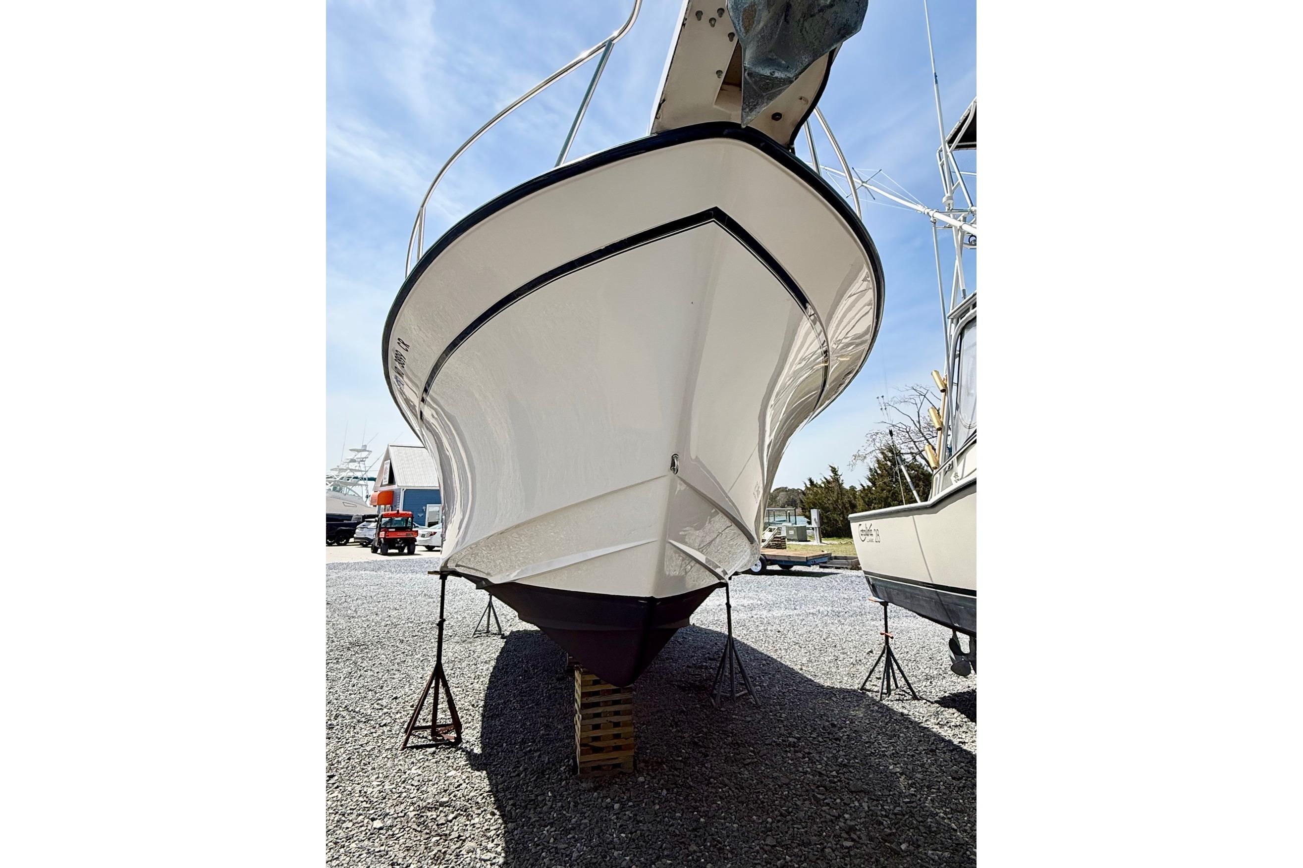 2002 Grady-White Express 330 boat on stands, viewed from the front, outdoors.