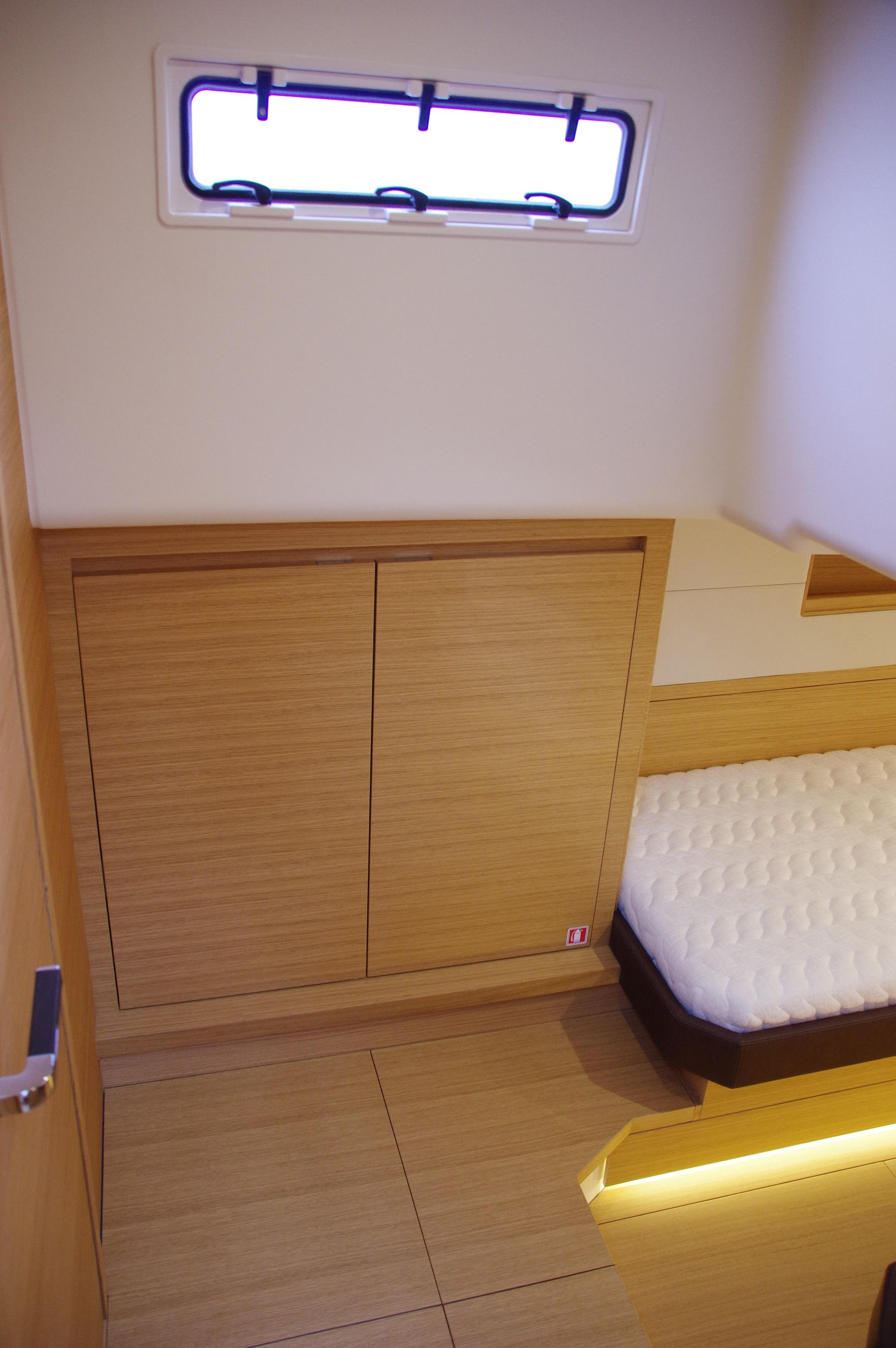 2025 Pardo Yachts 50 interior cabin with modern wood finish and cozy bed.
