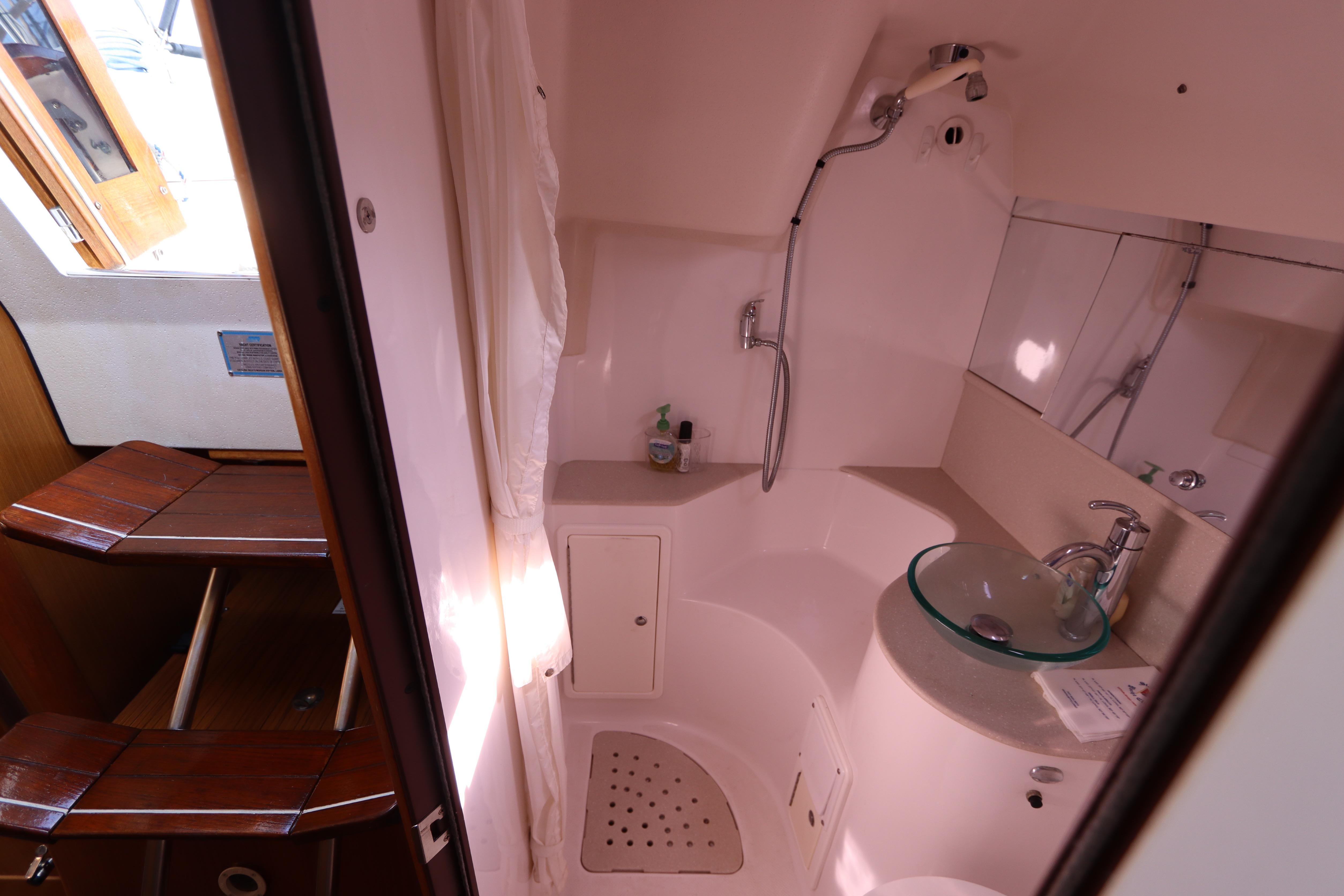 Bathroom interior of 2011 Catalina 355 sailboat with shower and glass sink.