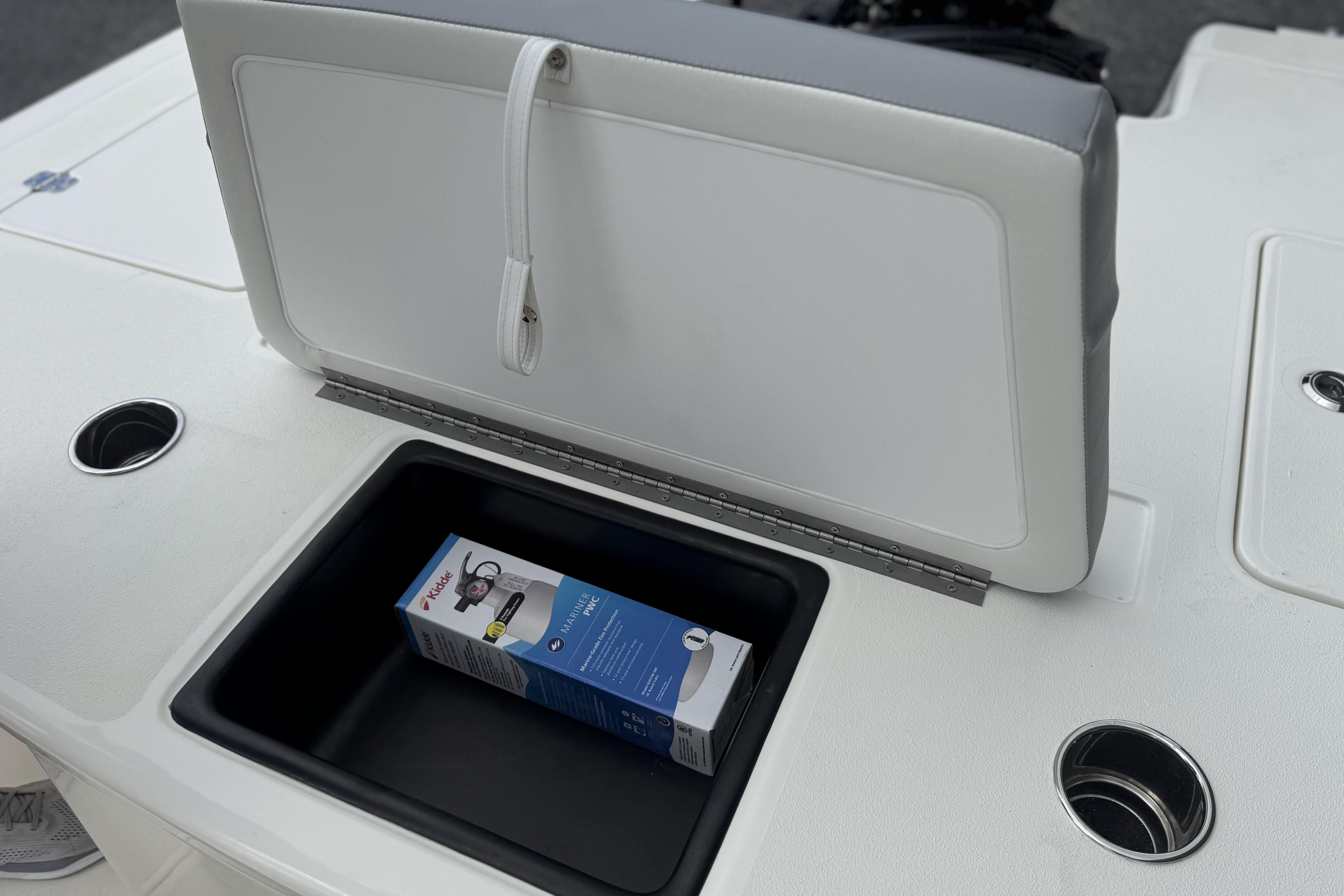 Open storage compartment on 2026 Mako 18 Pro Skiff boat with a box inside.