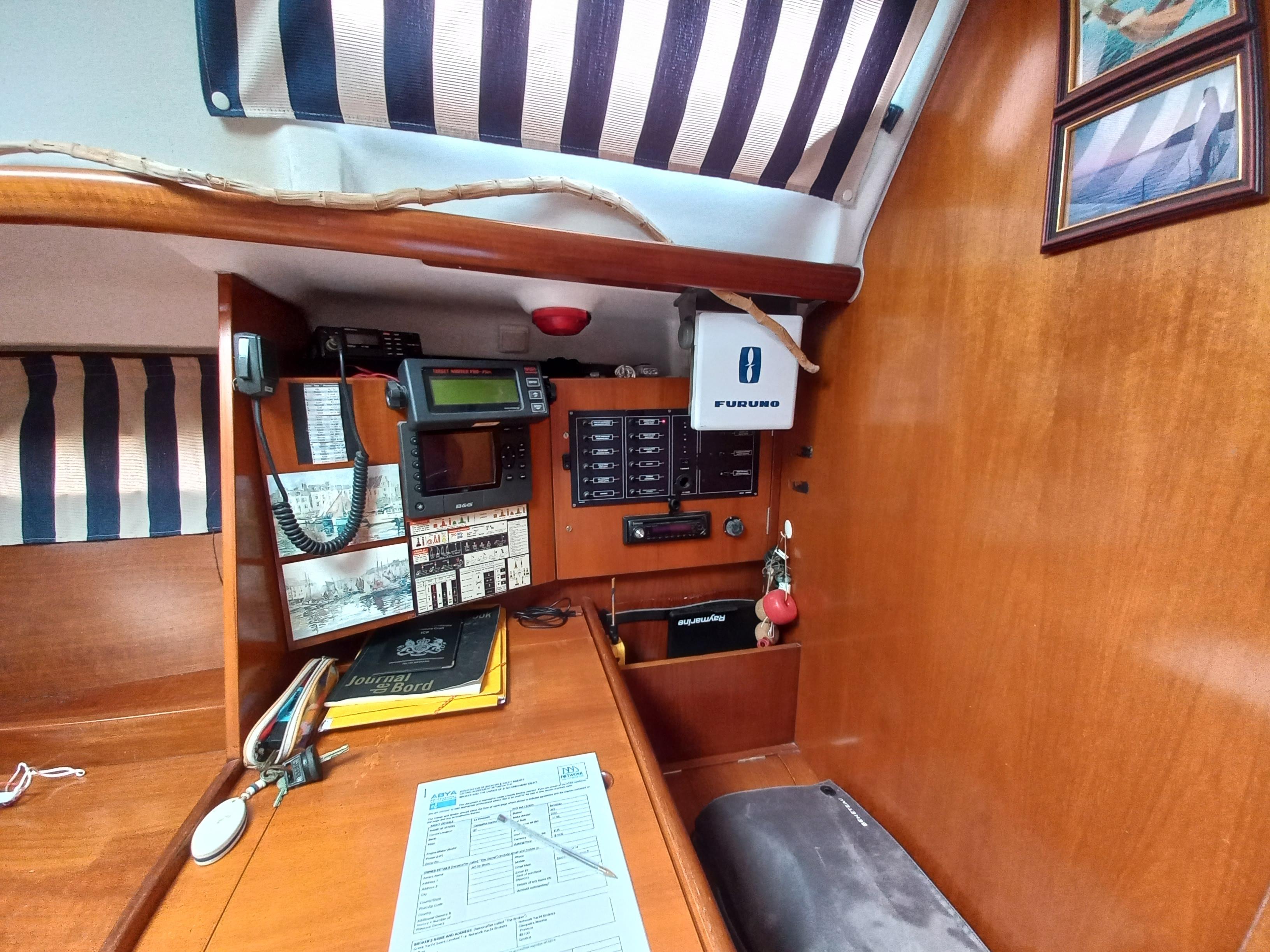 Navigation station of 2001 Beneteau Oceanis 393 sailboat with control panels and equipment.