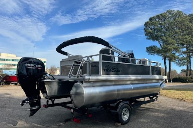 2026 Sun Tracker Bass Buggy 16 XL Select pontoon boat with Mercury engine on trailer.