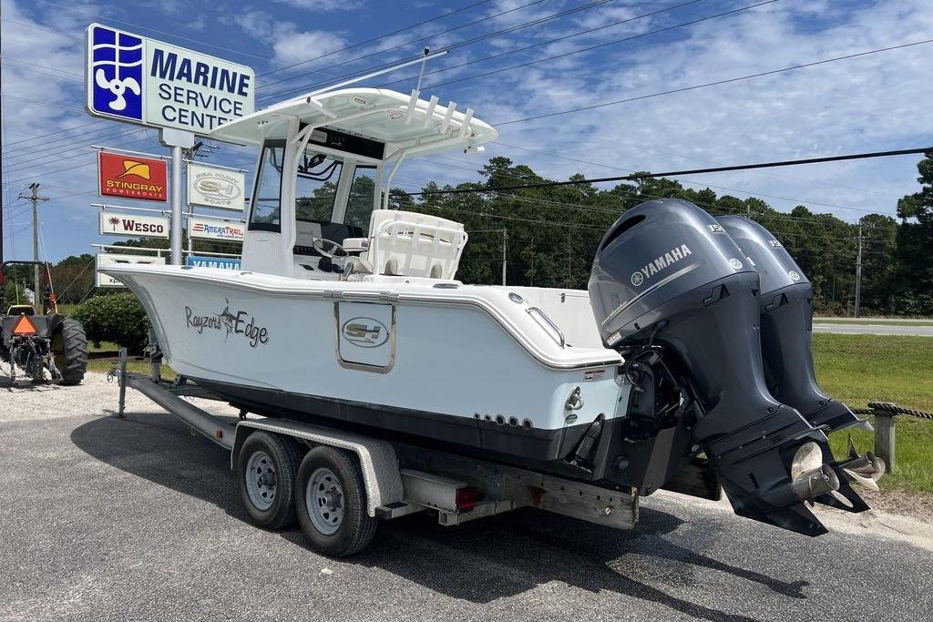 2021 Sea Hunt Gamefish 25 boat on trailer at marine service center.