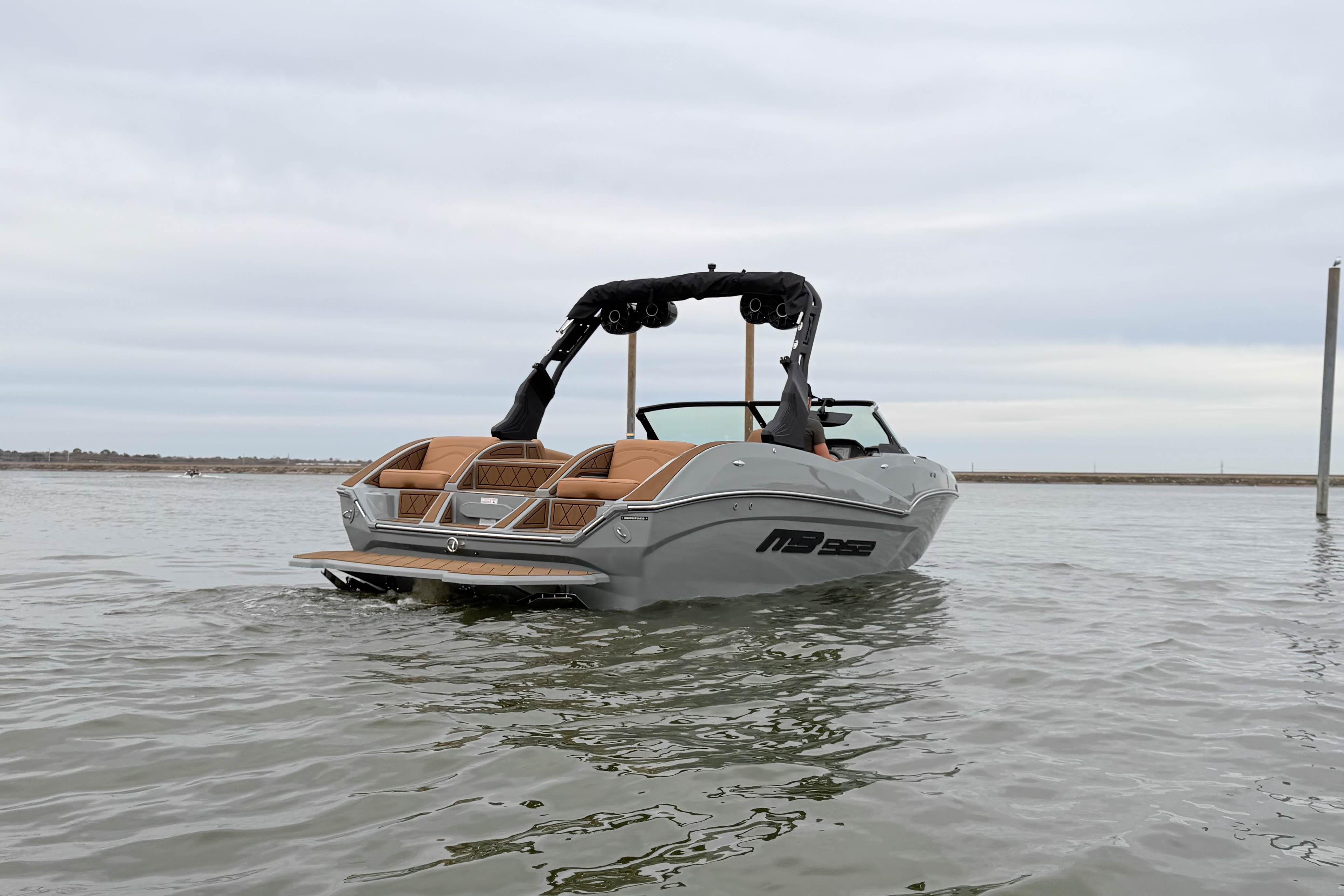 2026 MB B52 21 Alpha boat on calm water, showcasing sleek design and modern features.