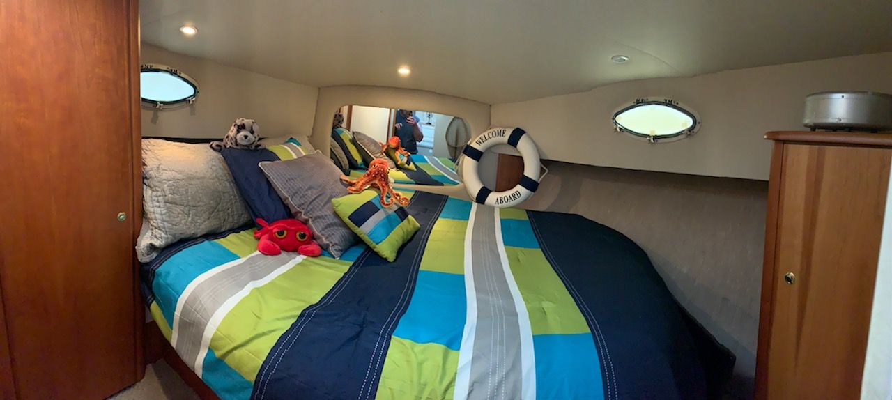 Interior of a 1998 Silverton 372/392 yacht with cozy bedroom.