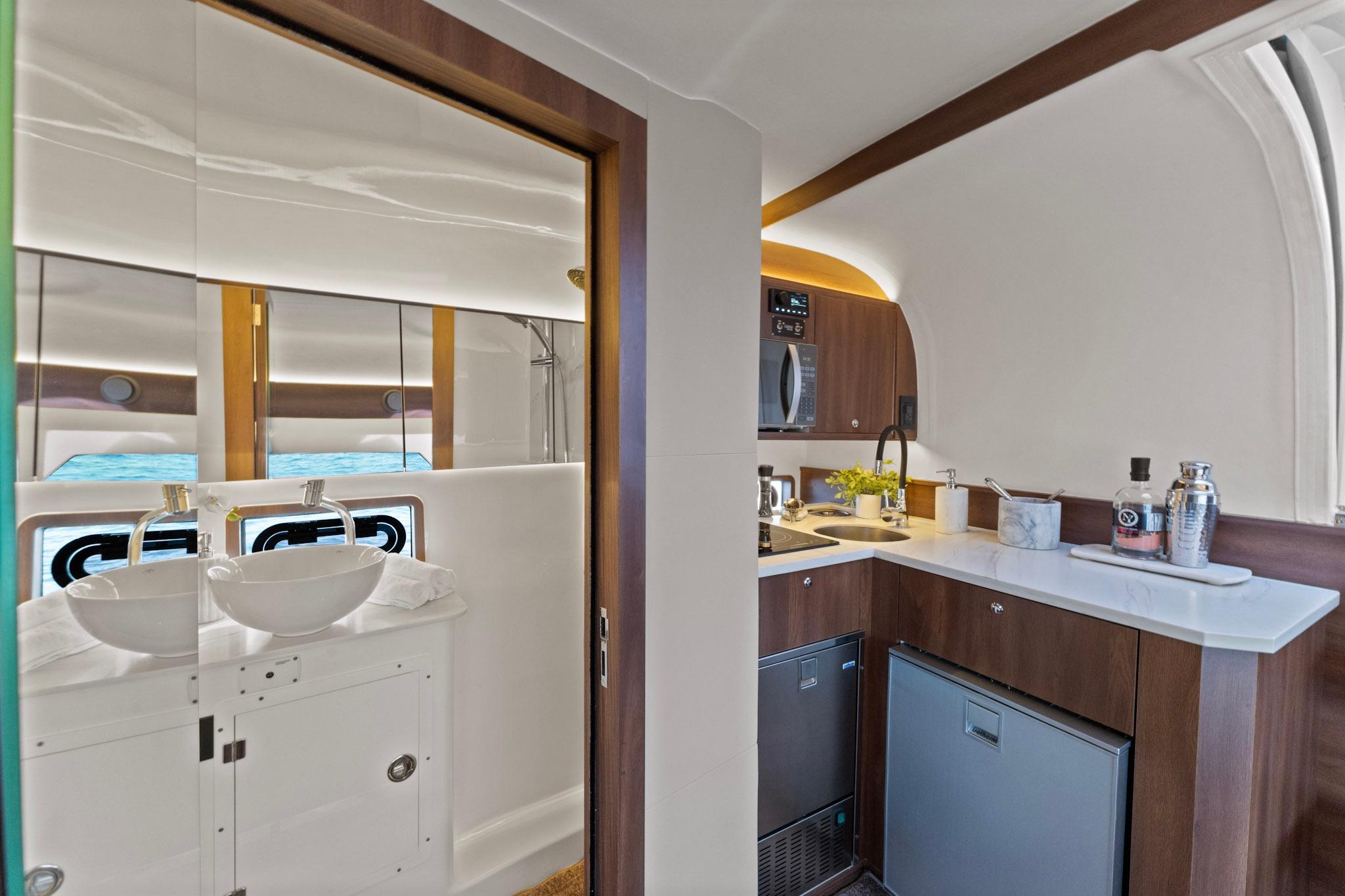 Luxurious interior of 2025 Valiatt 380GT yacht featuring modern kitchenette and bathroom.