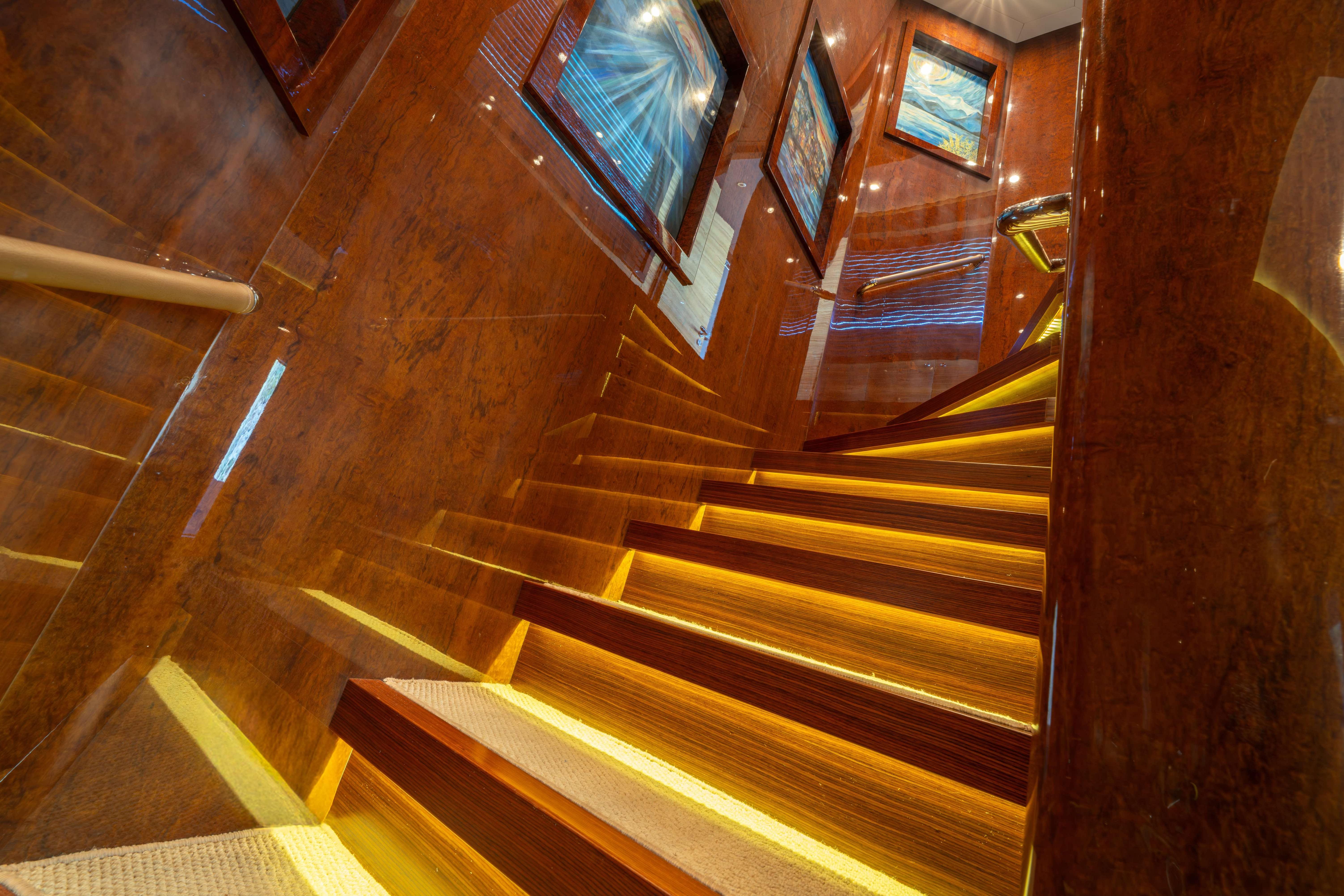 Luxurious wooden staircase with ambient lighting on Bilgin 147 yacht, 2014 model.