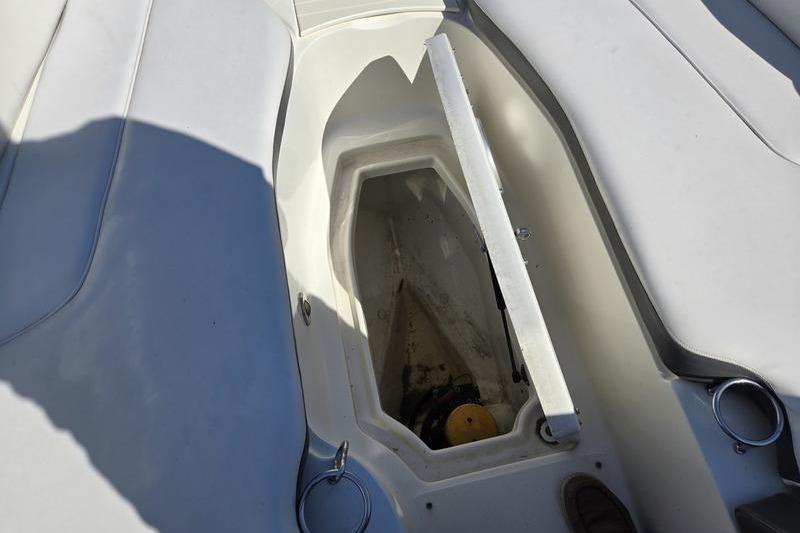 Open storage compartment on a 2011 Sea Ray 300 Sundeck boat.