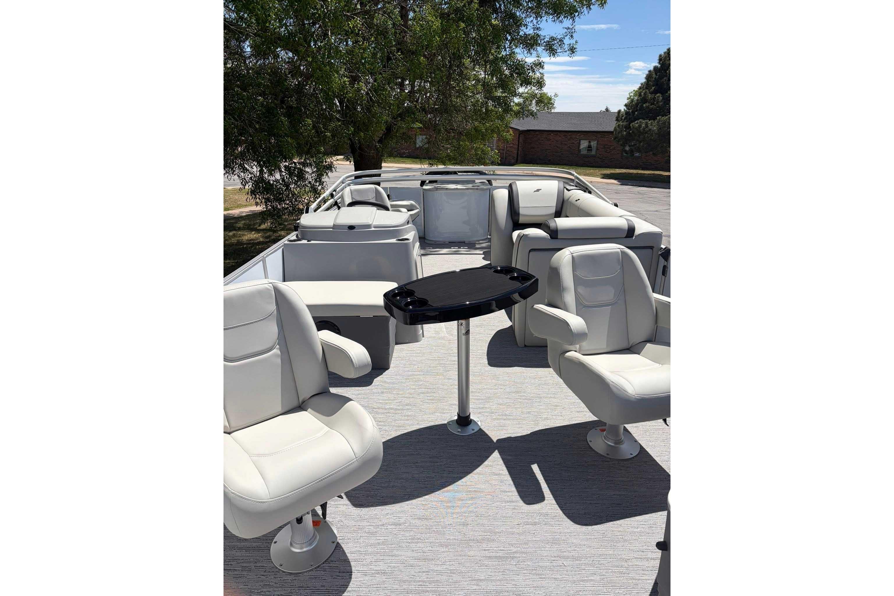 2026 Starcraft EX 22 FD4 pontoon boat interior with plush seating and table.