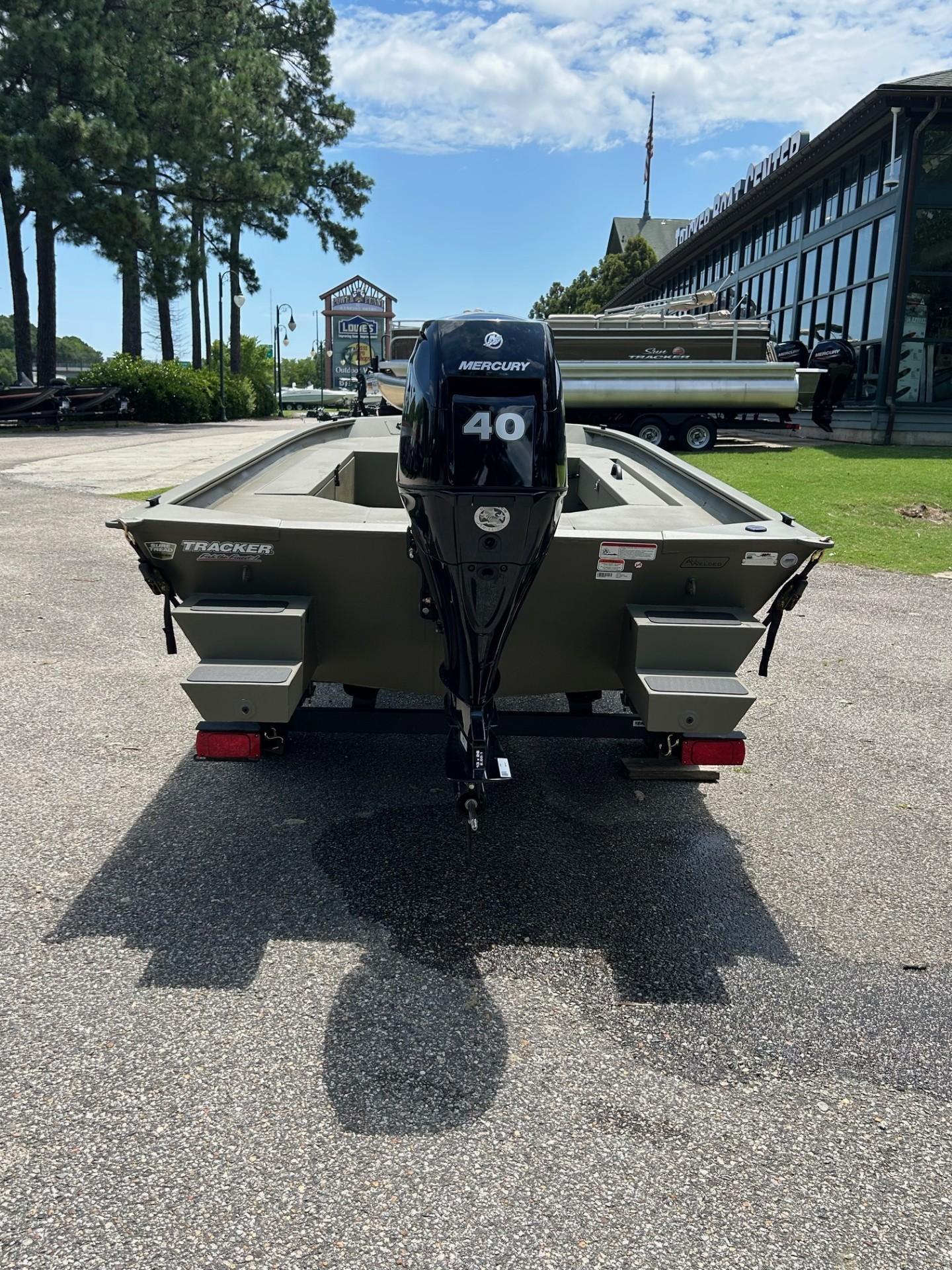 2025 Tracker Grizzly 1654 T Sportsman boat with Mercury 40 engine, parked outdoors.