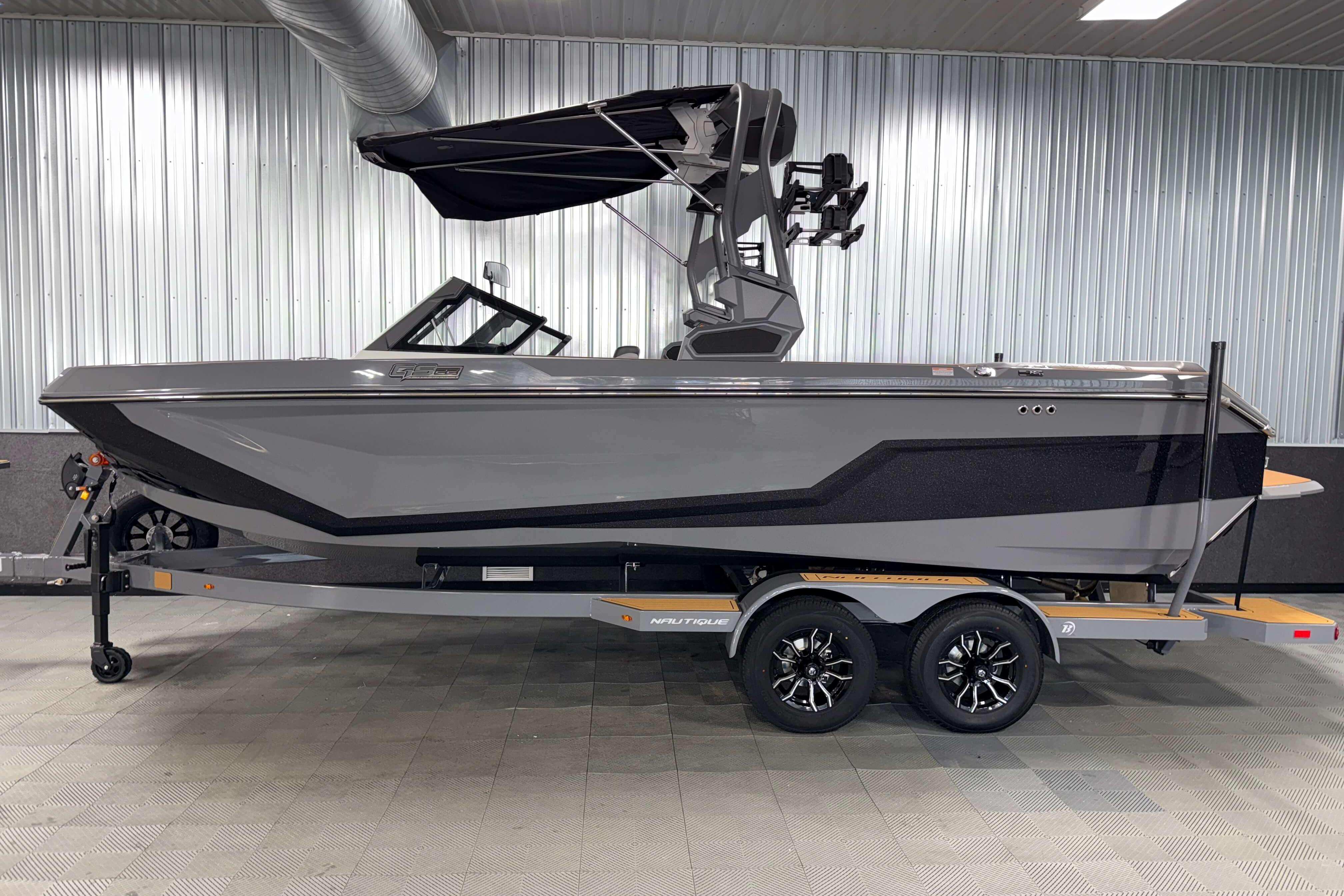 2026 Nautique Super Air Nautique GS22 boat on trailer in showroom.