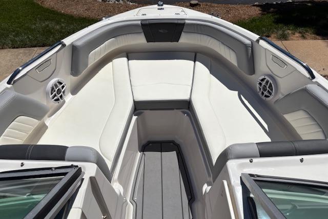 2023 Chaparral 21 SSi boat interior with white cushioned seating and modern design.