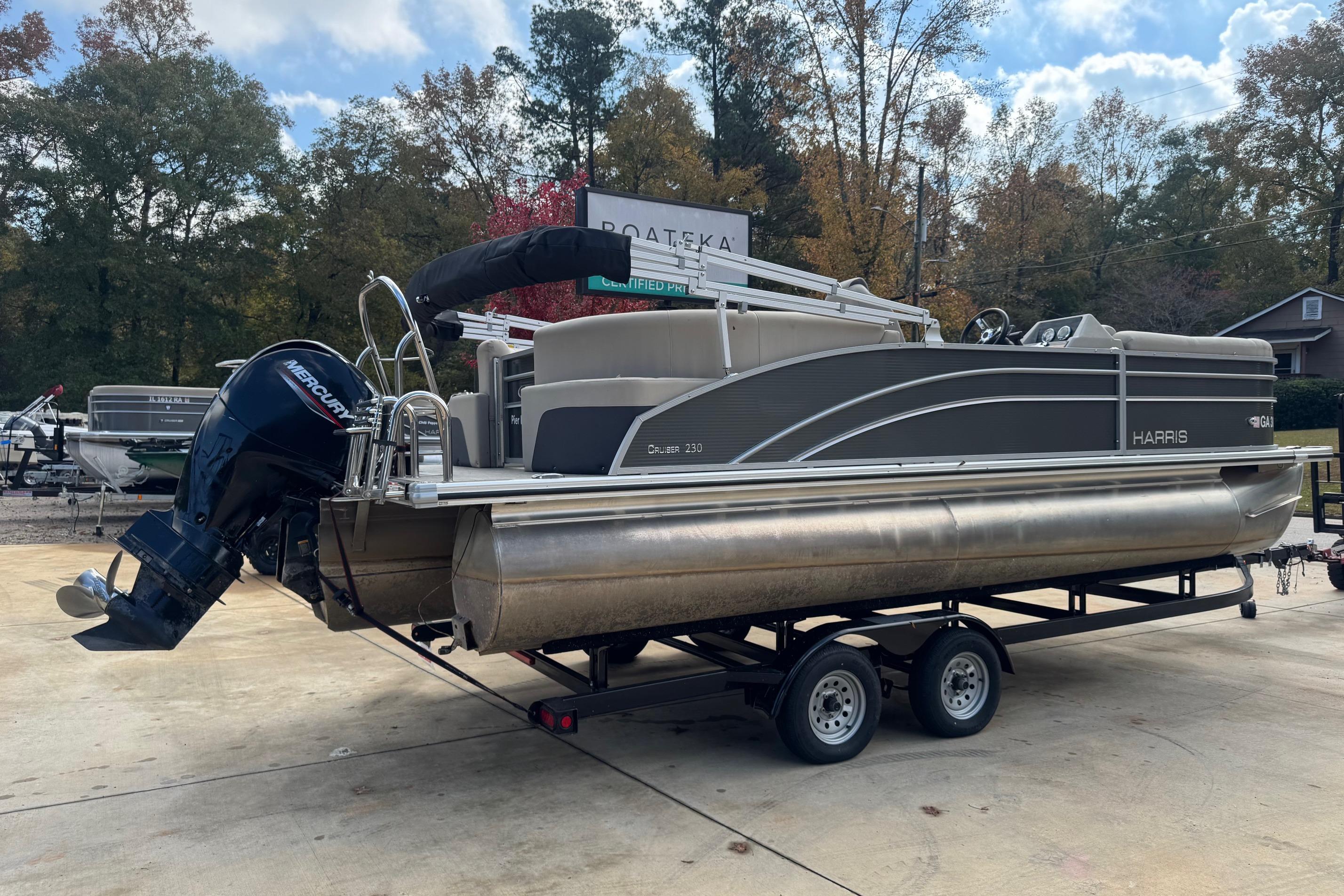 2023 Harris Cruiser 230 pontoon boat on trailer, outdoor setting.