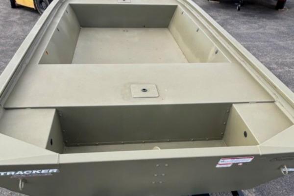 2026 Tracker Grizzly 1648 Utility boat, olive green, empty interior, parked on pavement.