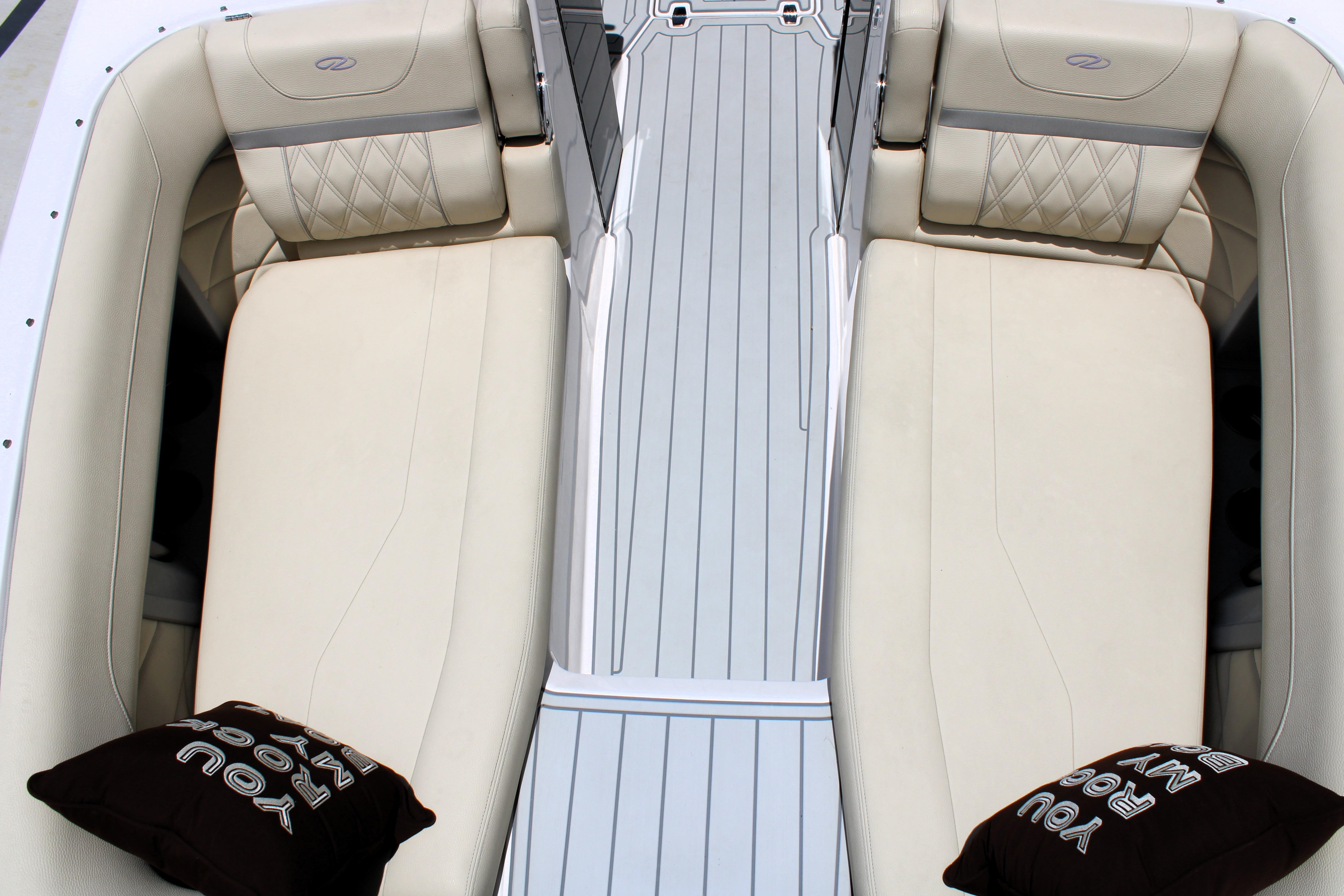2021 Regal 26 OBX boat interior with beige seating and decorative pillows.