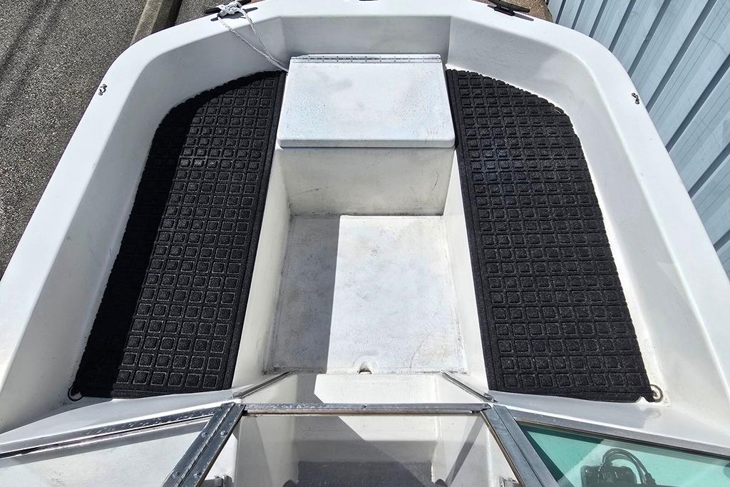 1971 Jupiter 15' Tri Hull boat interior with black textured flooring and white seating.