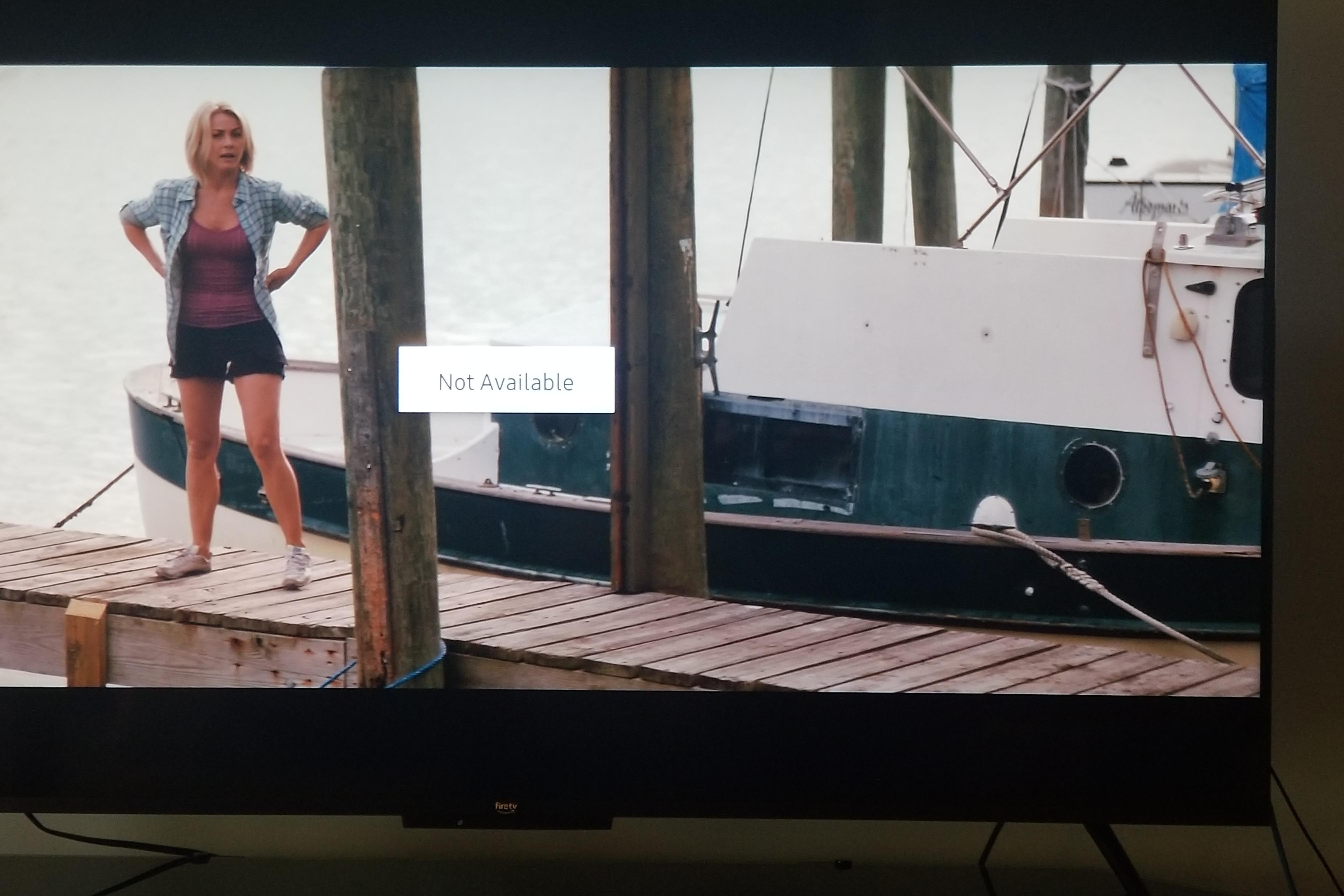 Woman standing on dock near 1974 Fales Navigator boat, with "Not Available" message displayed.
