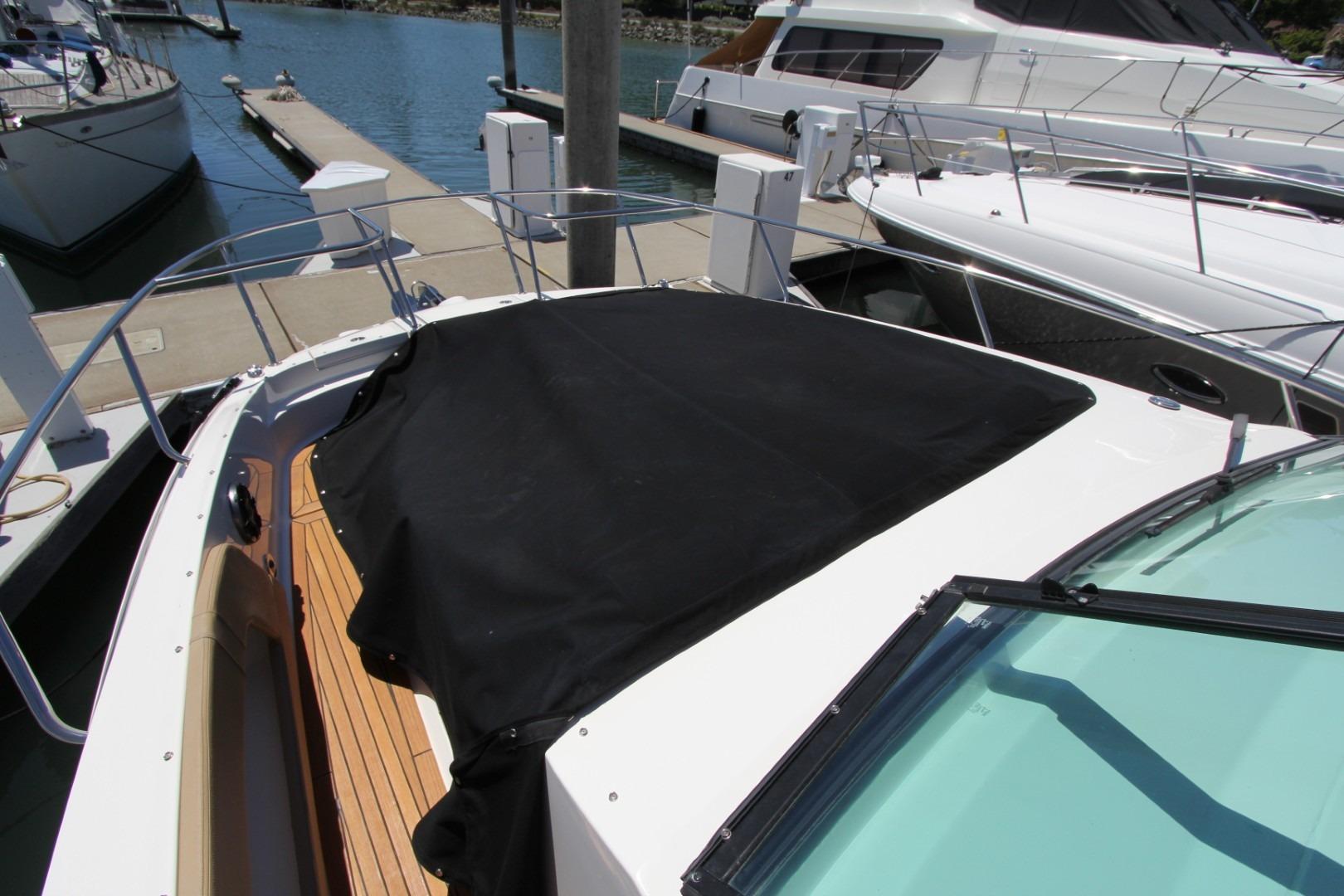 2021 Sea Ray Sundancer 320 Outboard docked, featuring covered bow area.