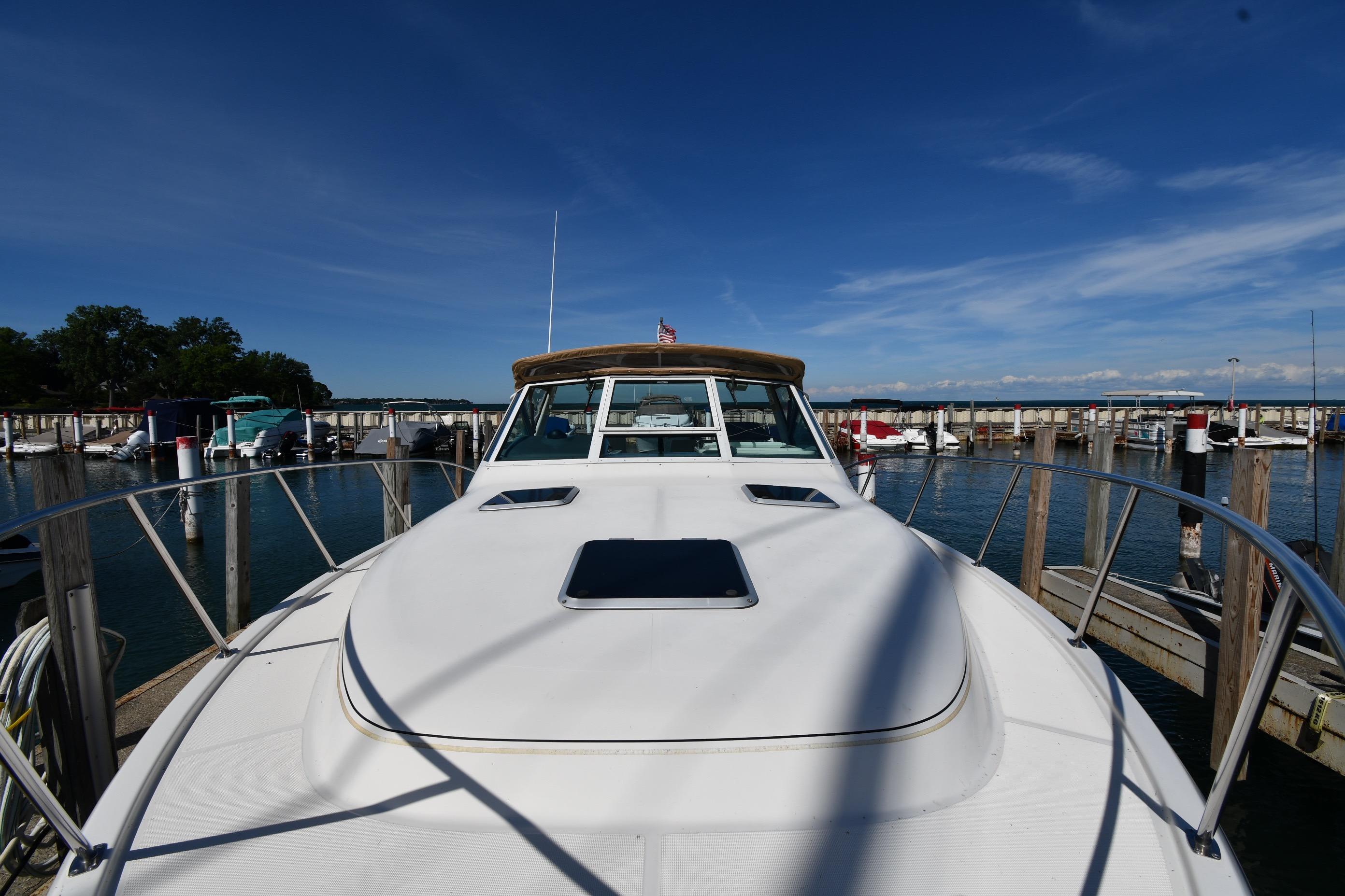 1998 Tiara Yachts 3100 Open docked at marina under clear blue sky.