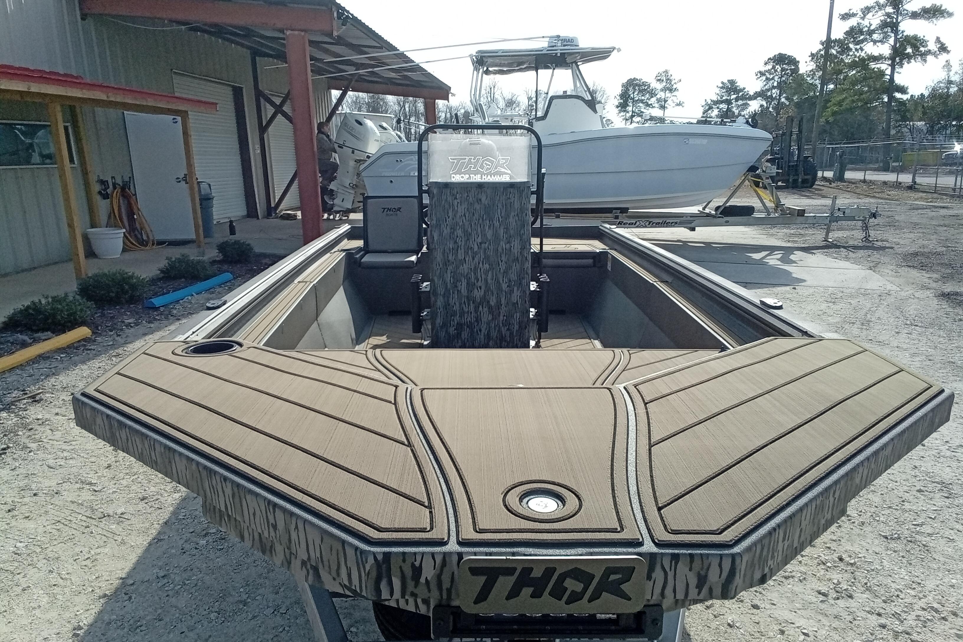 2026 Thor 1900 Low Country Elite boat with custom deck design, parked outdoors.