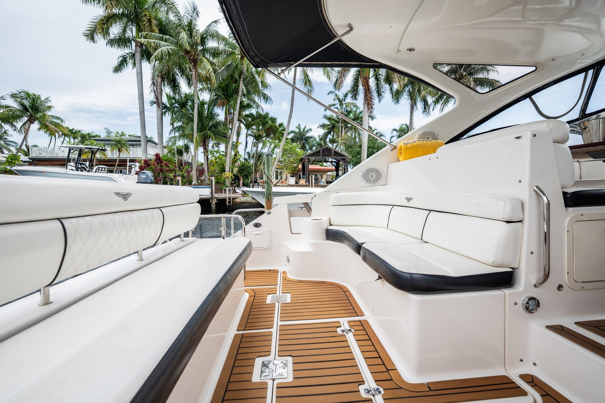 Luxurious 2008 Regal Commodore 4460 yacht interior with white seating and teak flooring.