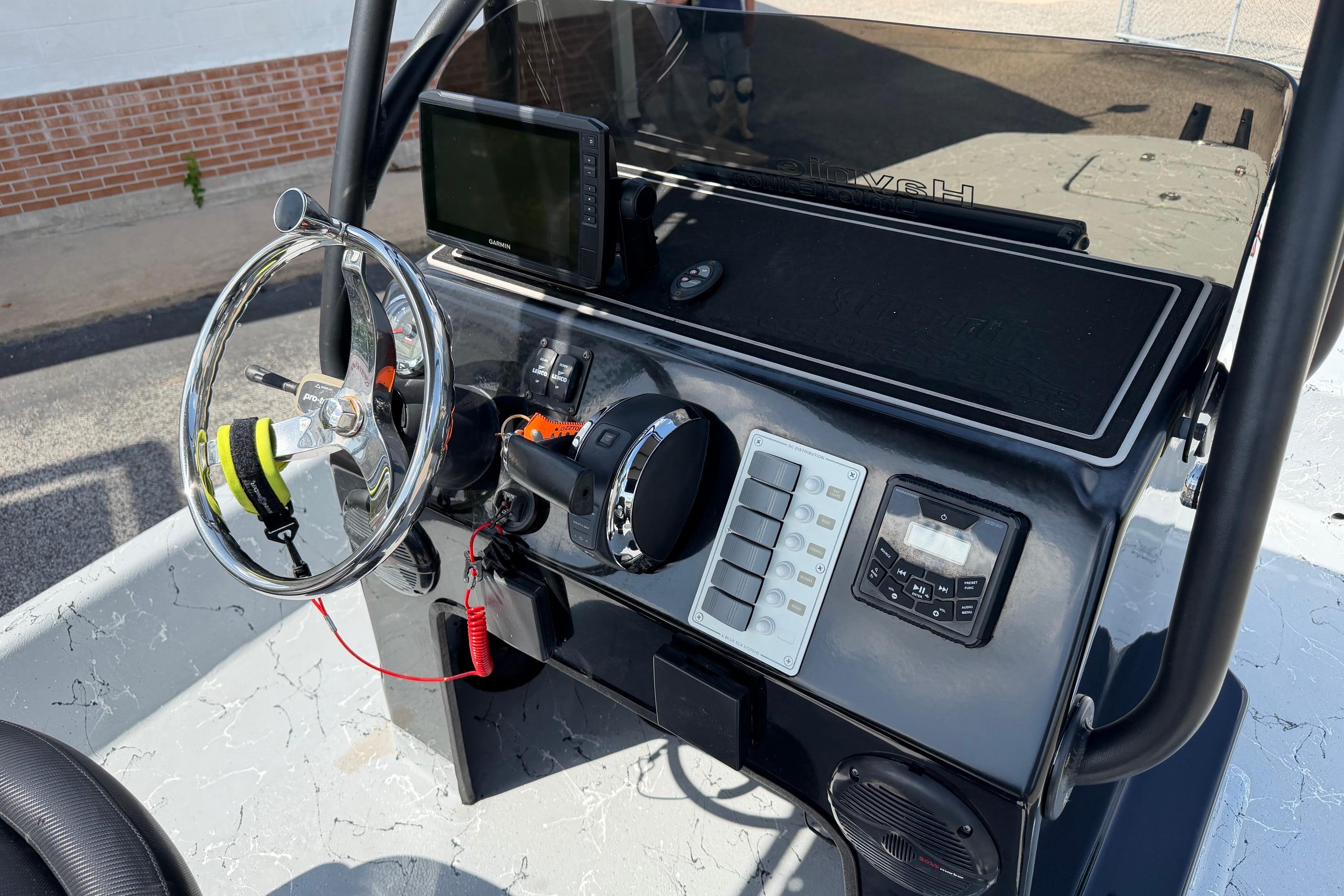 2023 Haynie 23 Super Cat boat dashboard with steering wheel and electronic controls.