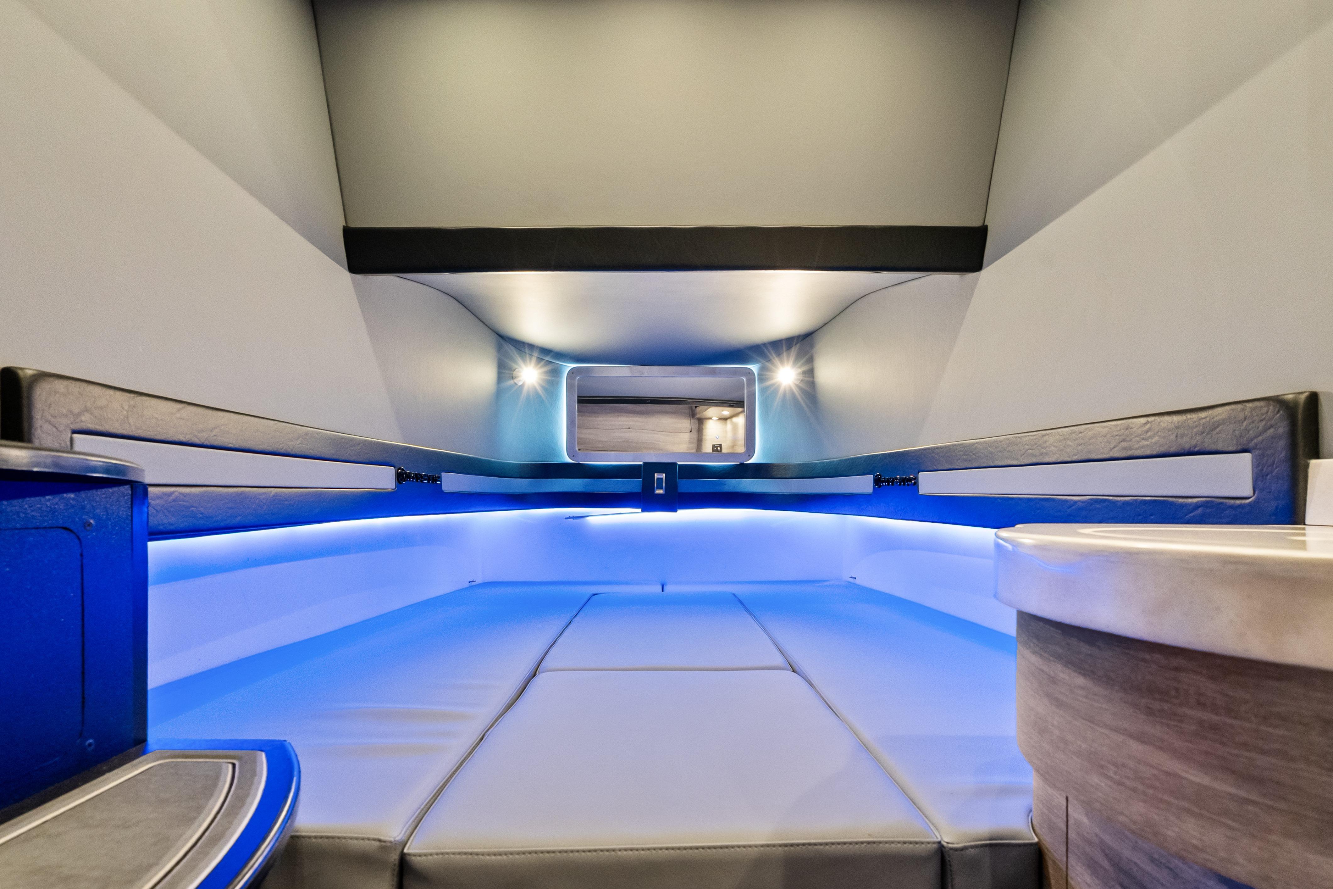 Interior of 2027 Mystic Powerboats M4200, featuring sleek design and ambient blue lighting.