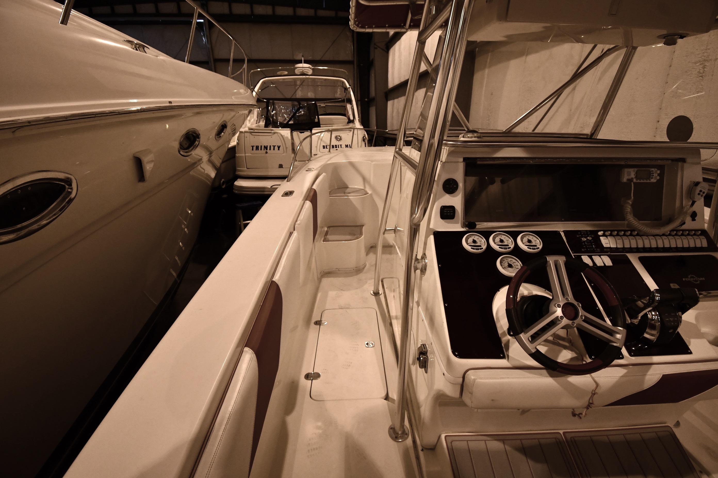 2001 Fountain 38 Center Console boat interior with steering wheel and control panel.