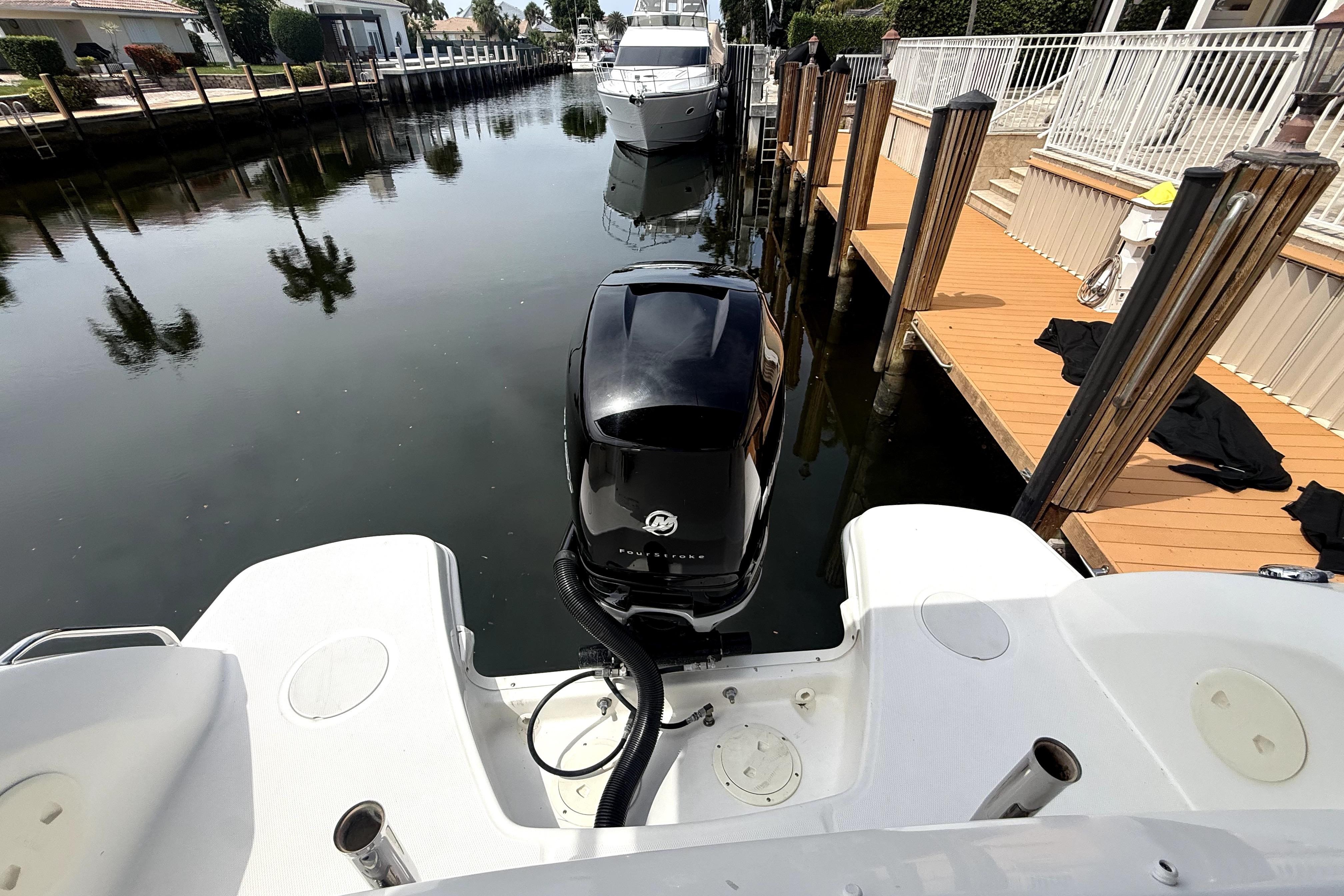 2018 Boston Whaler 230 Vantage docked in a serene canal setting.