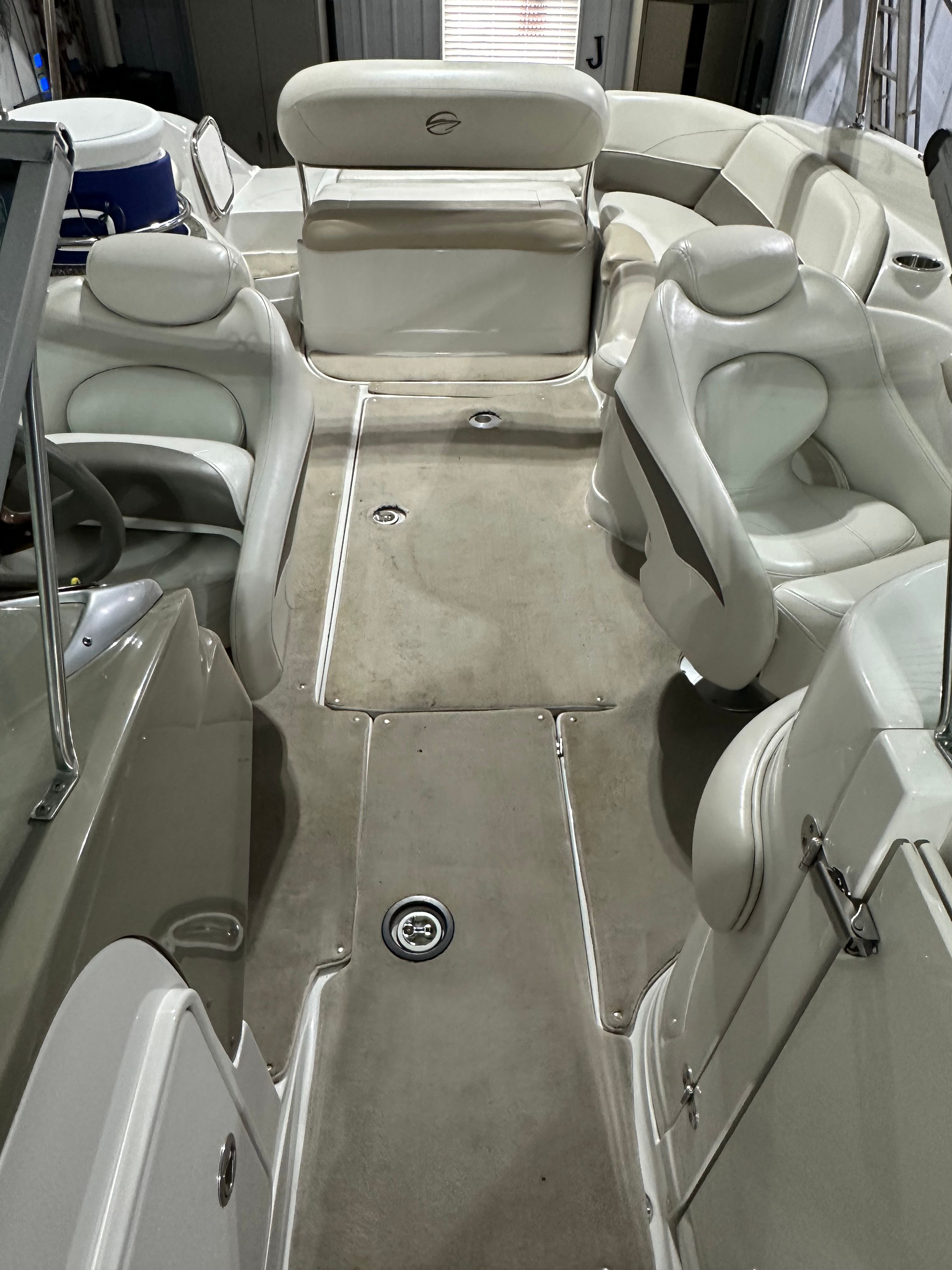 Interior view of a 2007 Crownline 252 EX boat with beige seating and gray flooring.