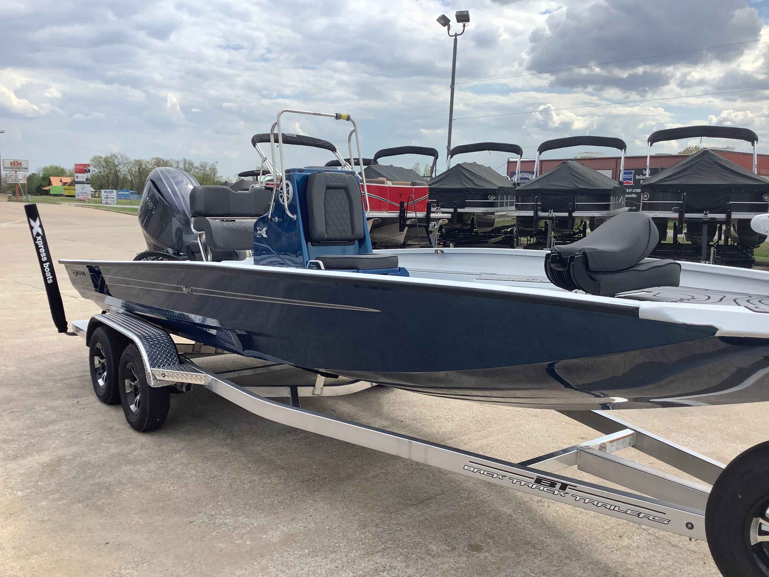 2026 Xpress H22B Bay boat on trailer outdoors.