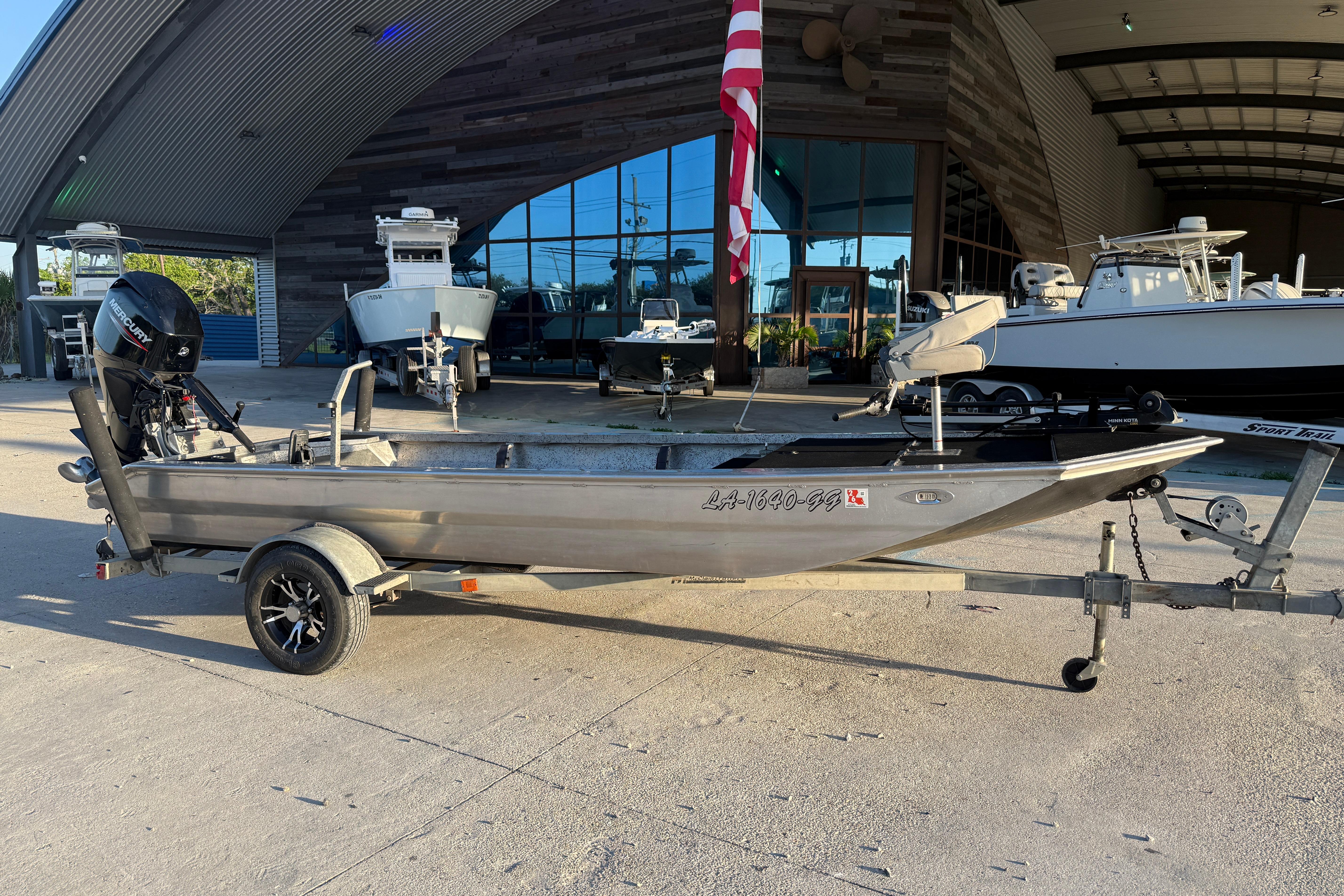 2017 Homemade 1754 boat on trailer outside a modern building with American flag.