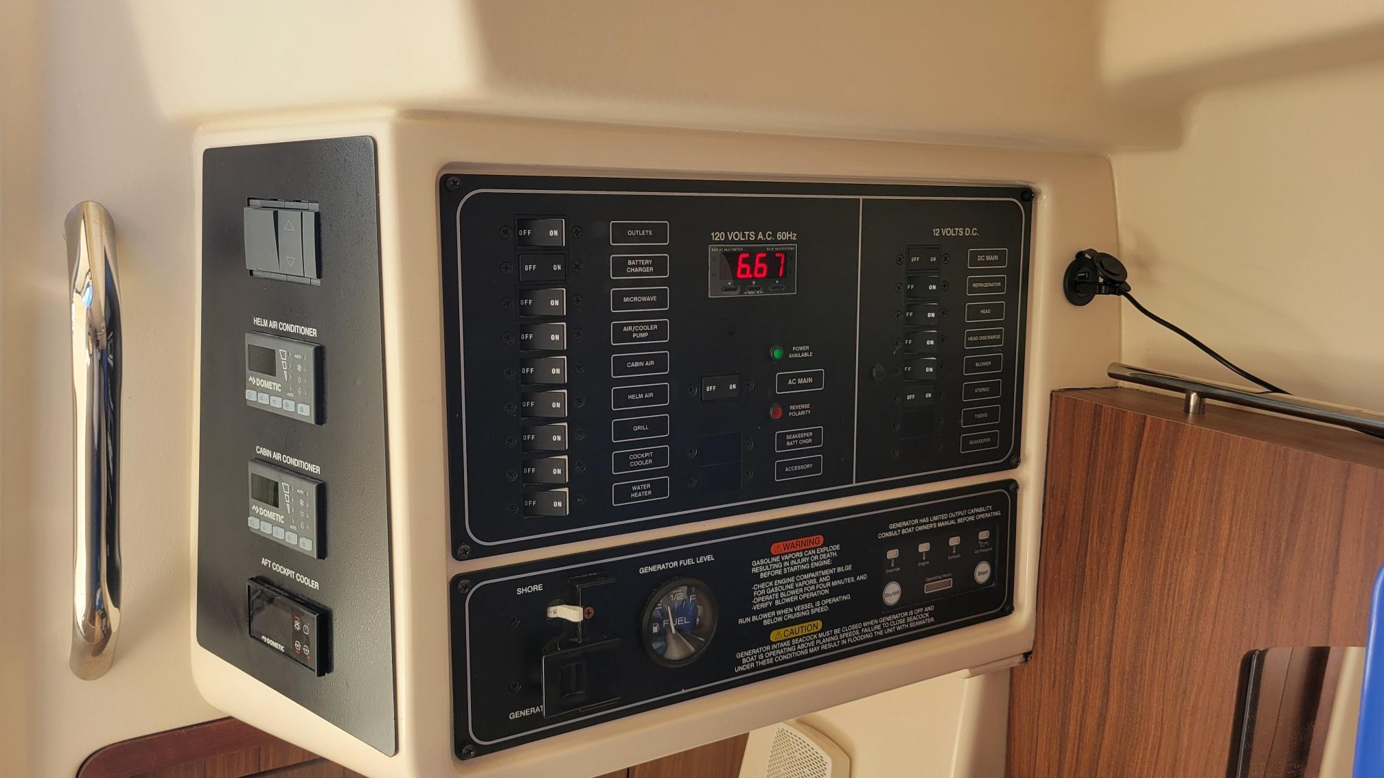 Control panel of 2021 Grady-White Freedom 335 boat, featuring various switches and displays.