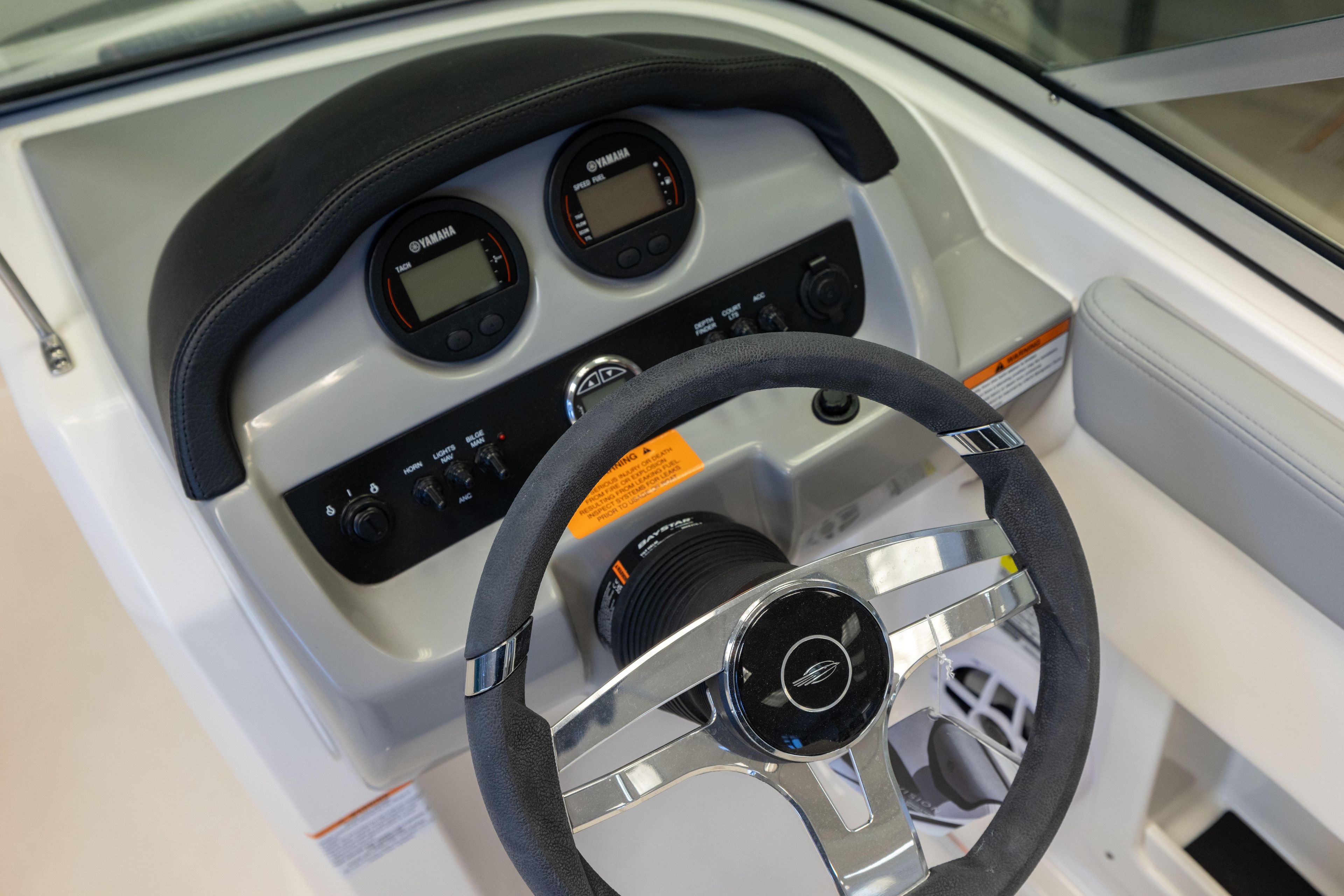 2024 Chaparral 19 SSi OB dashboard with steering wheel and Yamaha gauges.