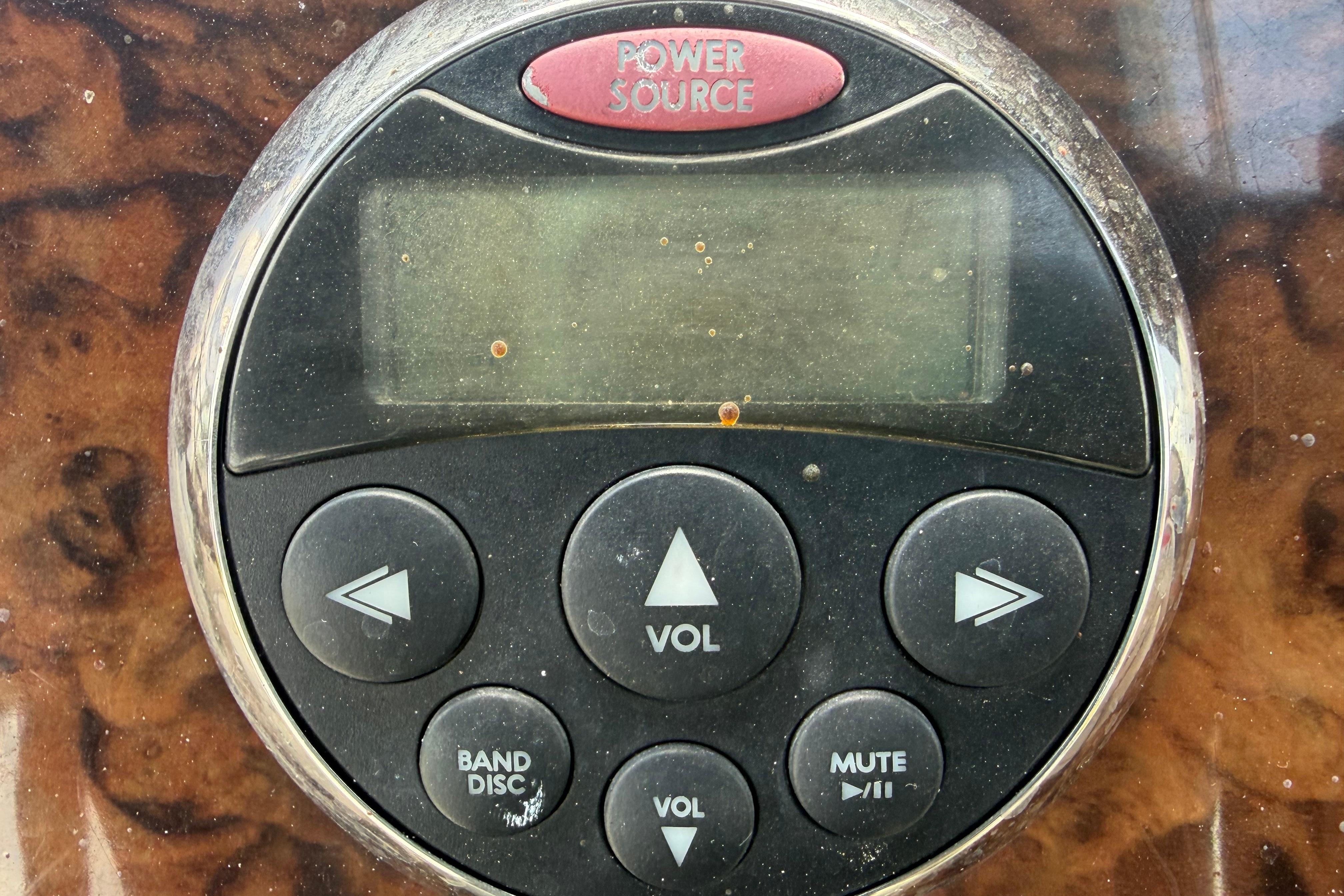 Close-up of a 2006 Sea Ray 250 Amberjack boat stereo control panel.
