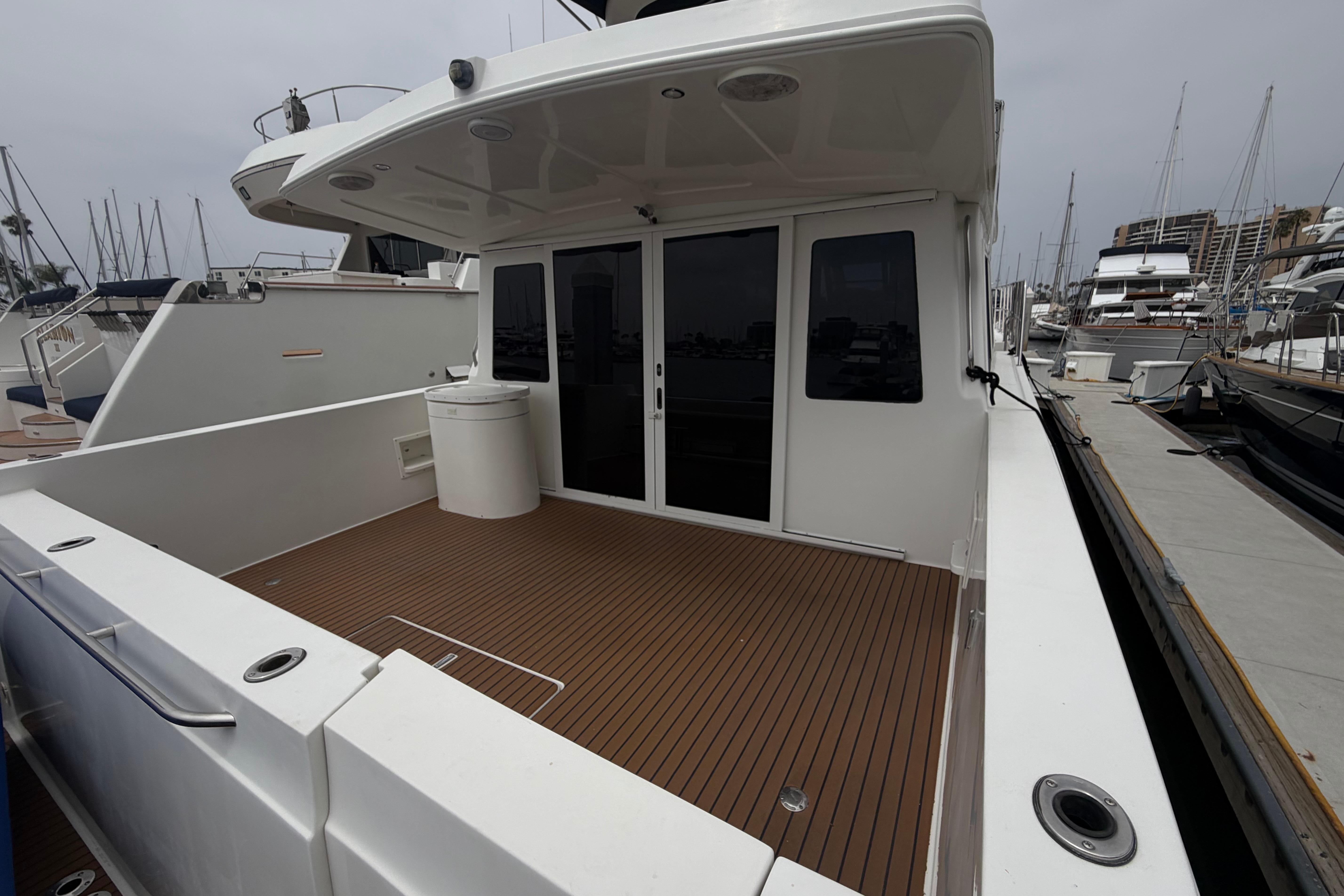 2005 Navigator 53 Pilot House yacht with spacious deck and modern design at marina.