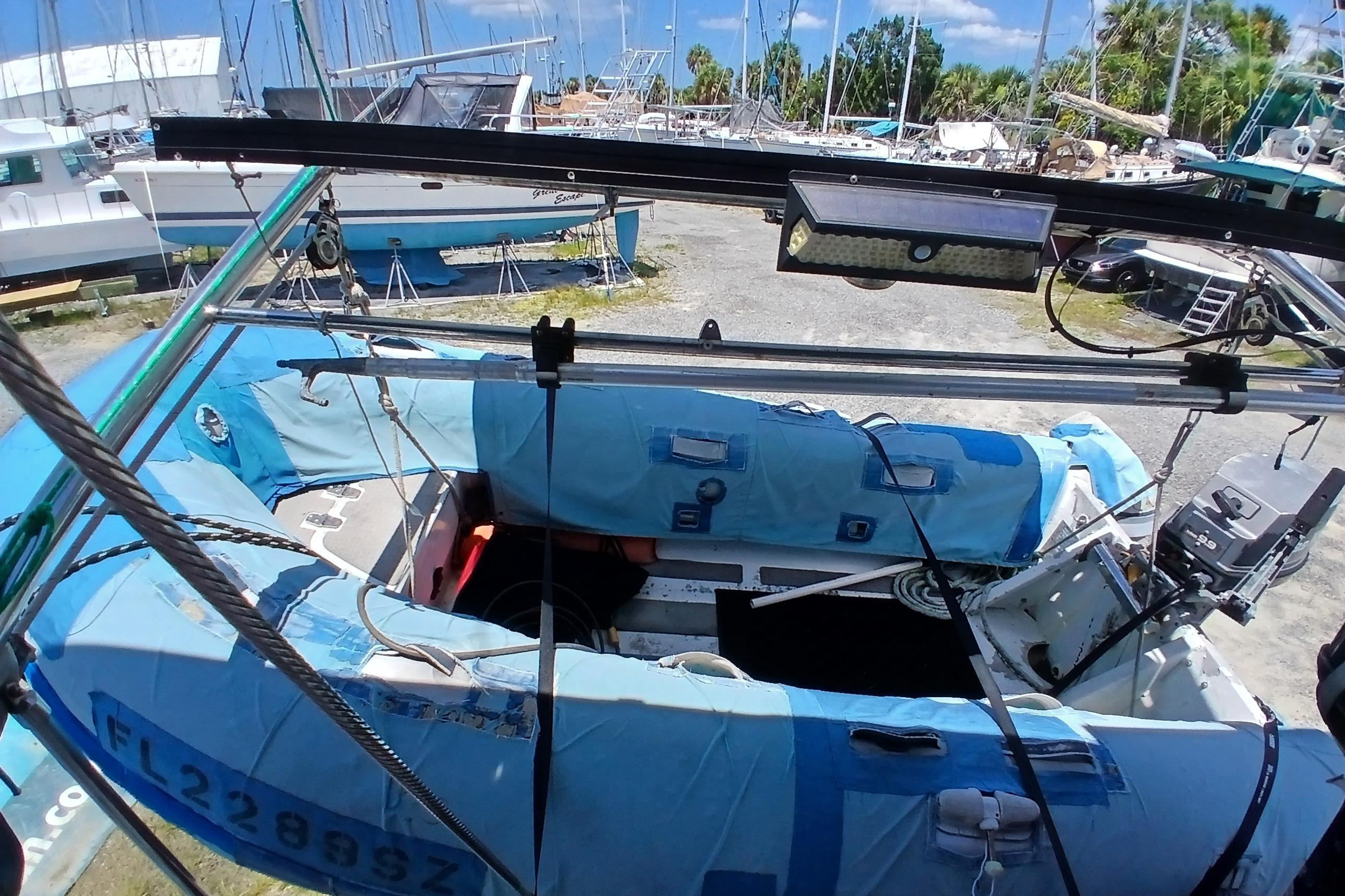 Catalina 42 MkII sailboat from 1995, docked with covered equipment and visible outboard motor.