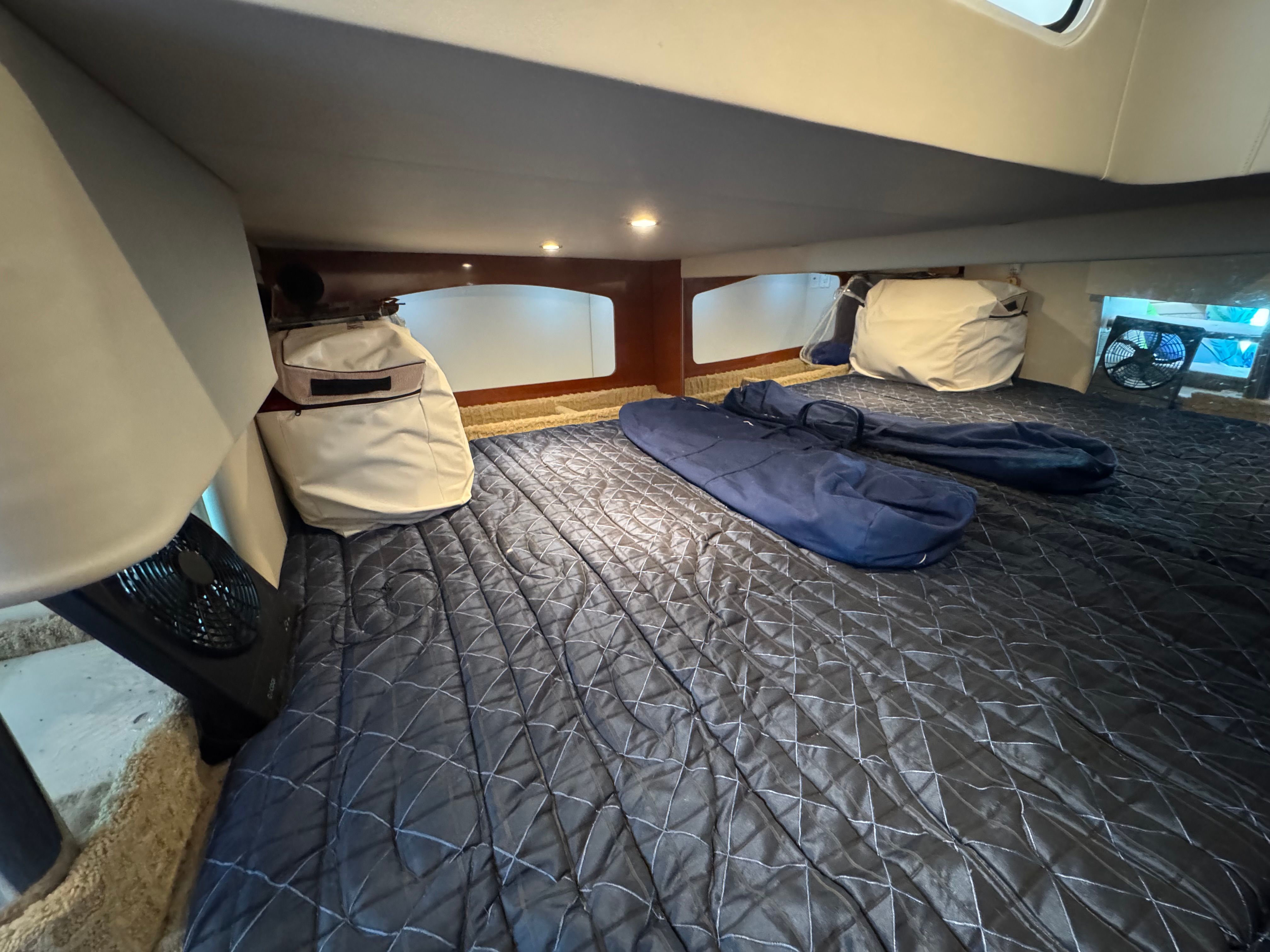 Interior of a yacht with padded flooring and bags.