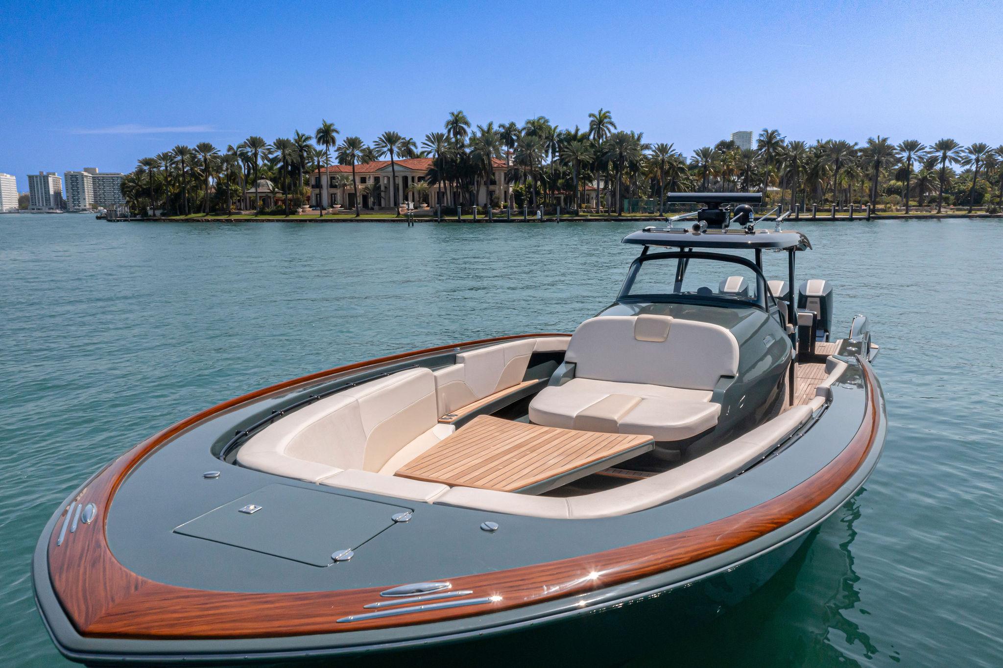 2025 Buddy Davis PININFARINA 47 CC luxury boat on serene water with palm trees.