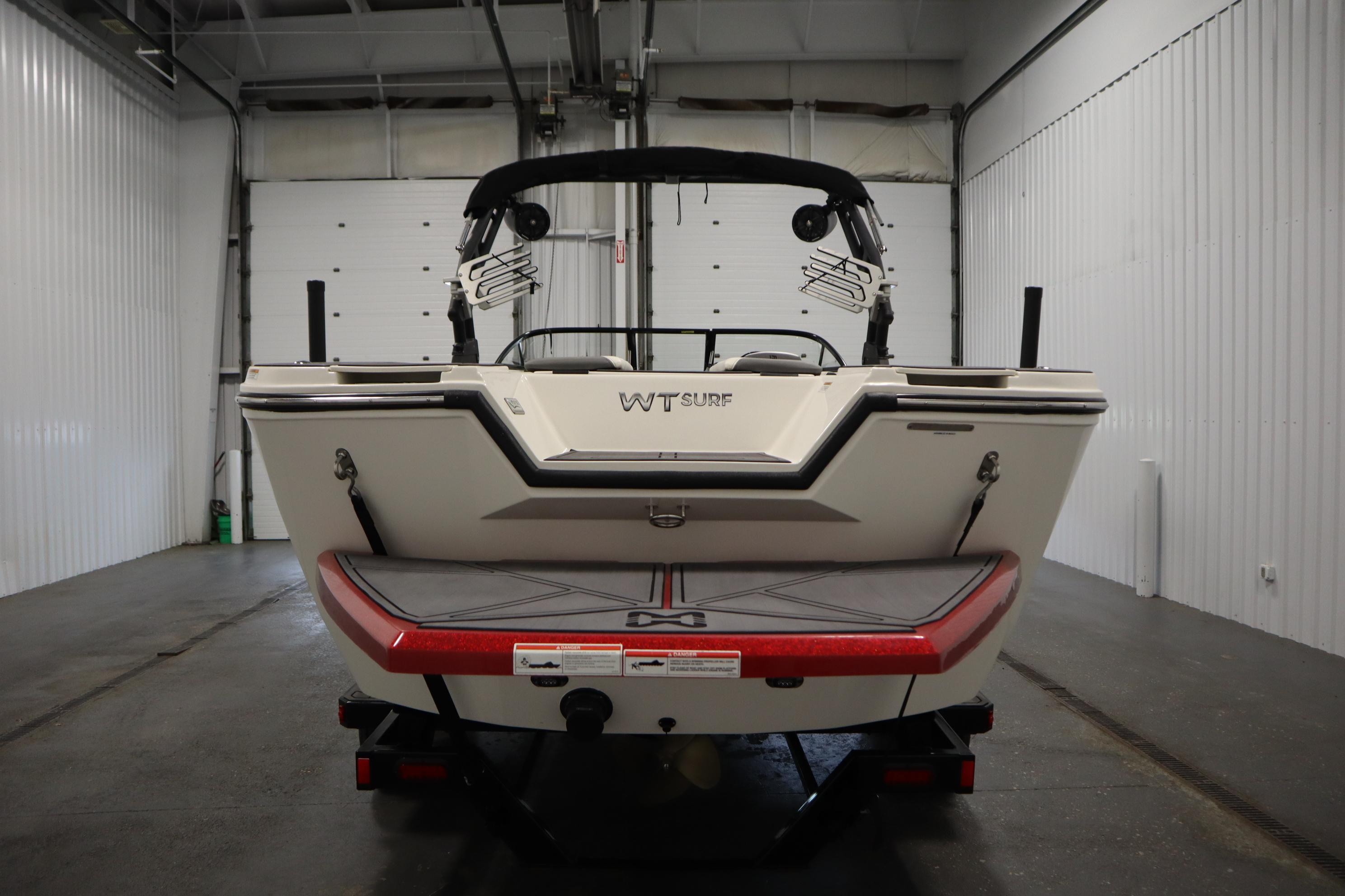 2023 Heyday WT Surf boat in a garage, rear view showcasing sleek design.