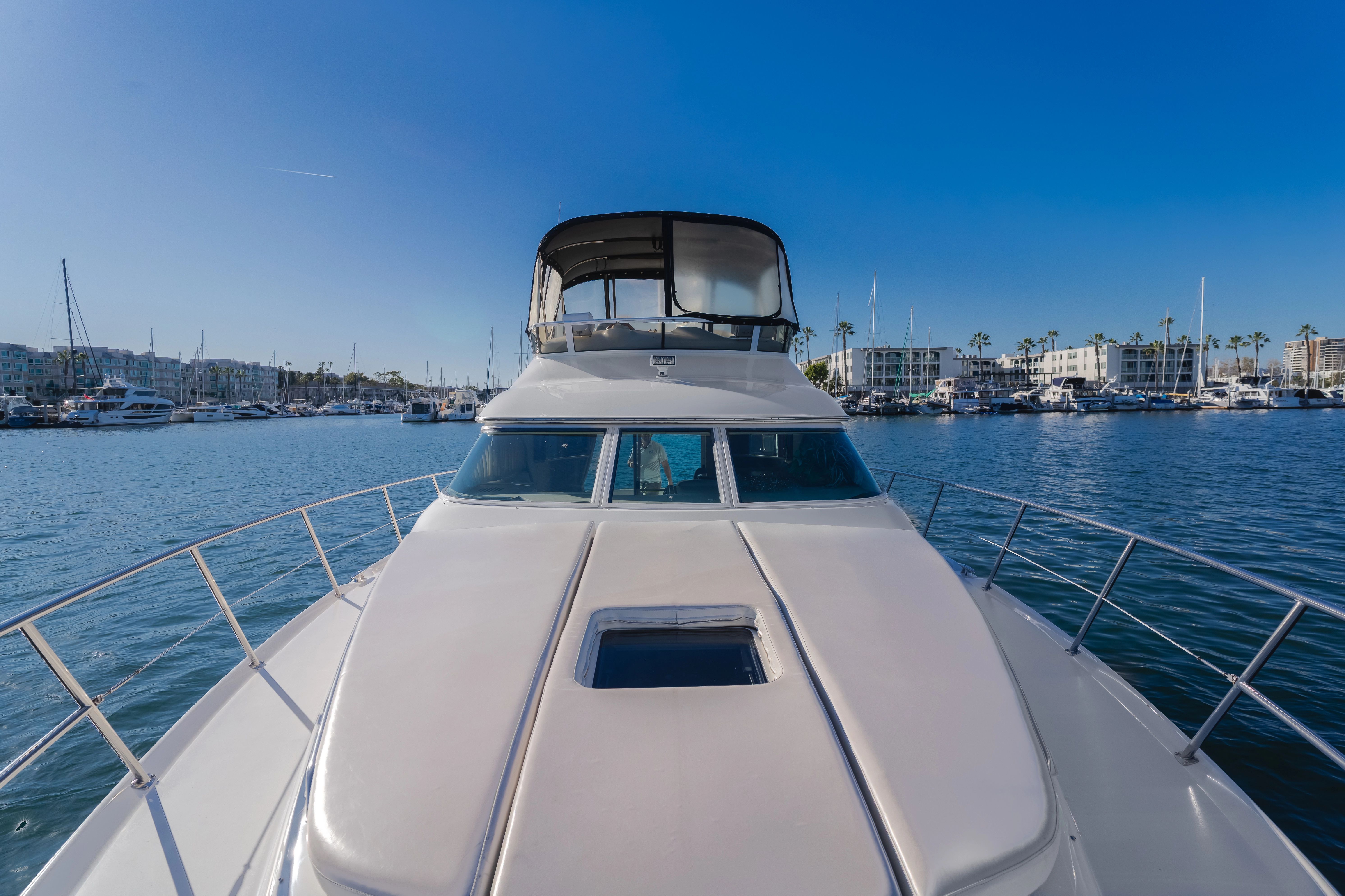 Sea Ray 400 Sedan Bridge 2002 on calm water in harbor.
