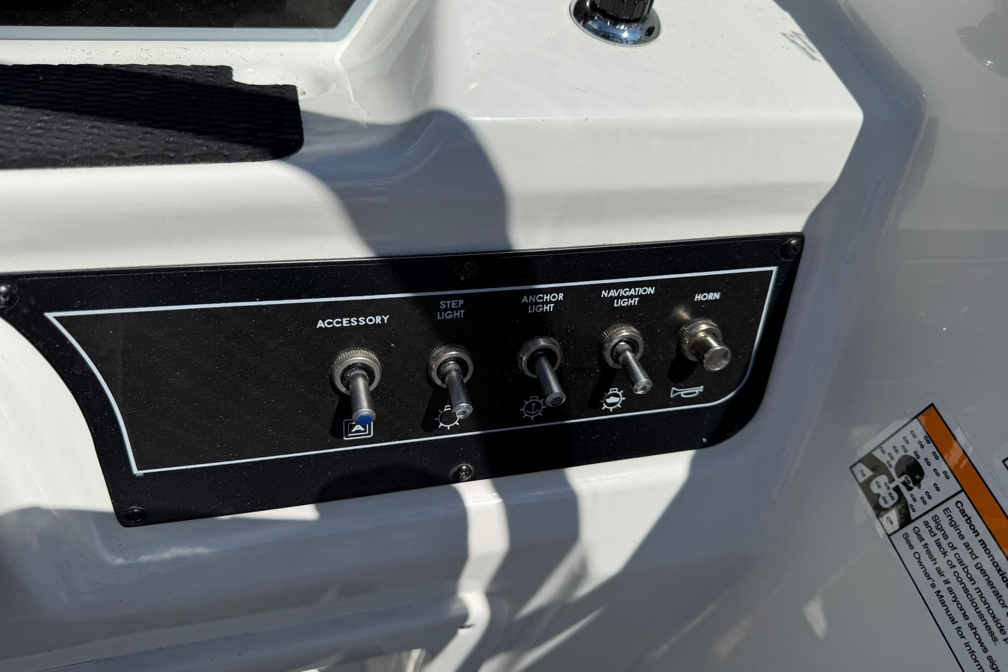 Control panel of 2026 Bayliner D20 boat with switches for lights and horn.