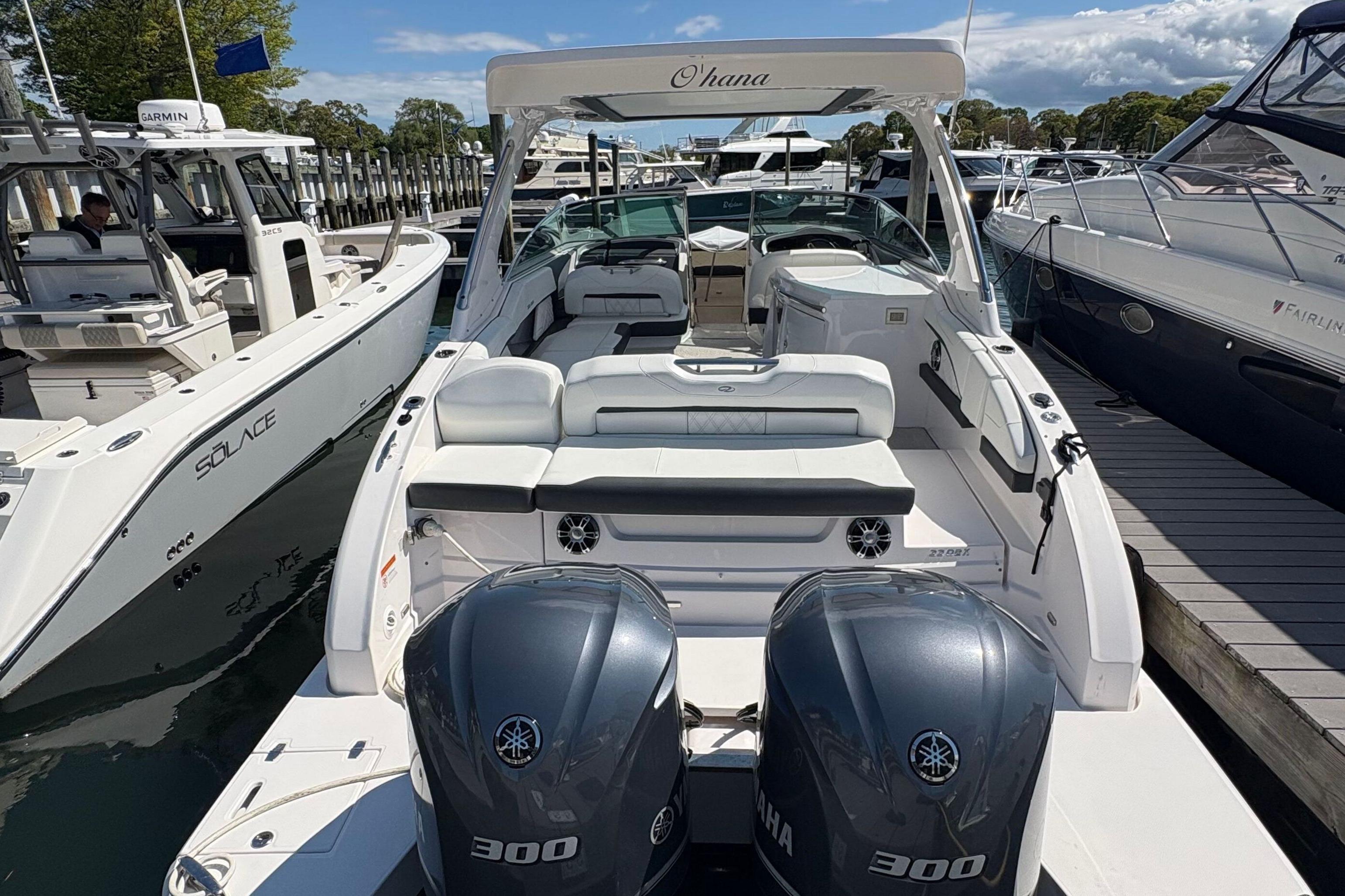 2020 Regal 33 OBX boat docked, featuring twin Yamaha 300 engines and spacious seating.